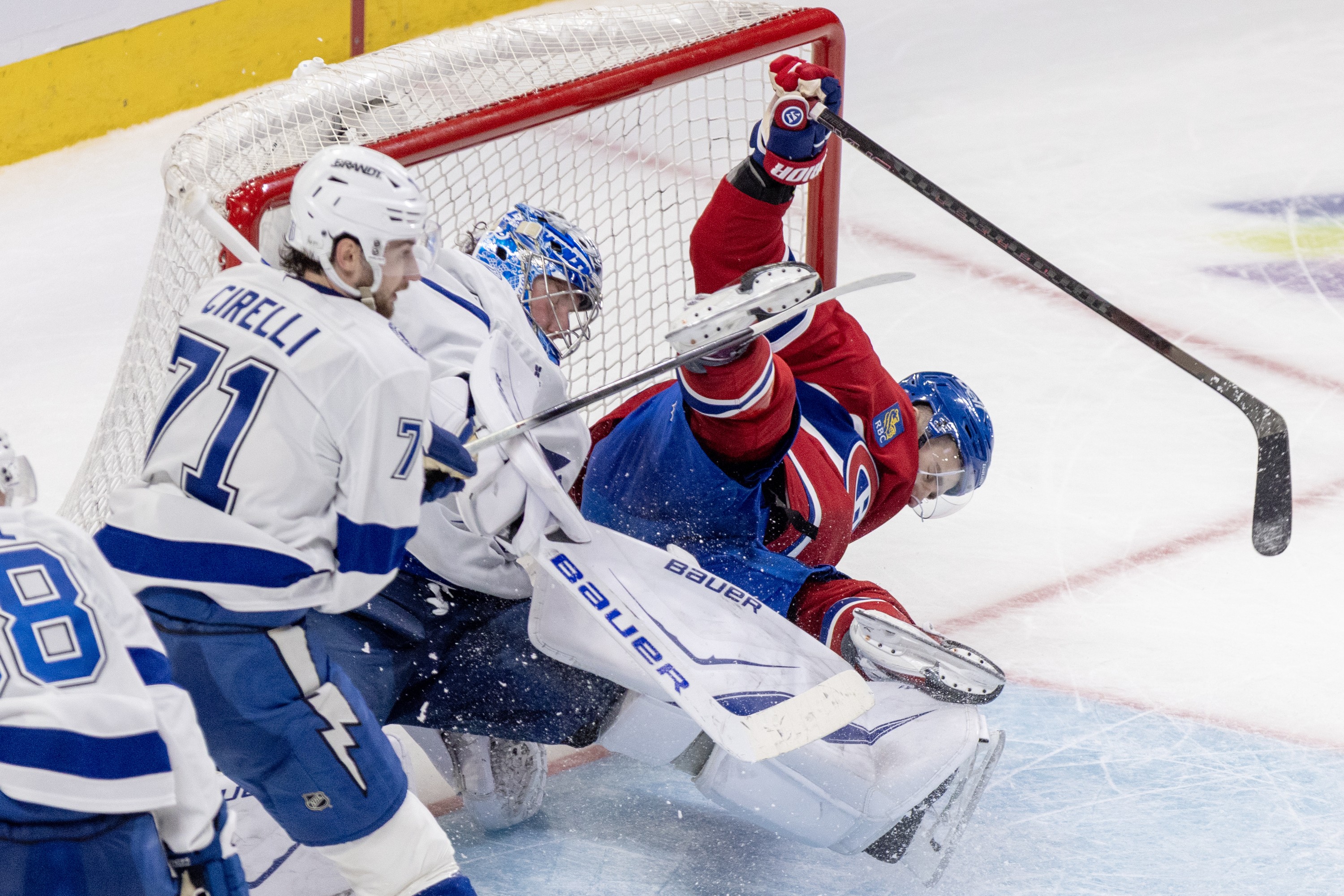 Hockey player crashes into the net.
