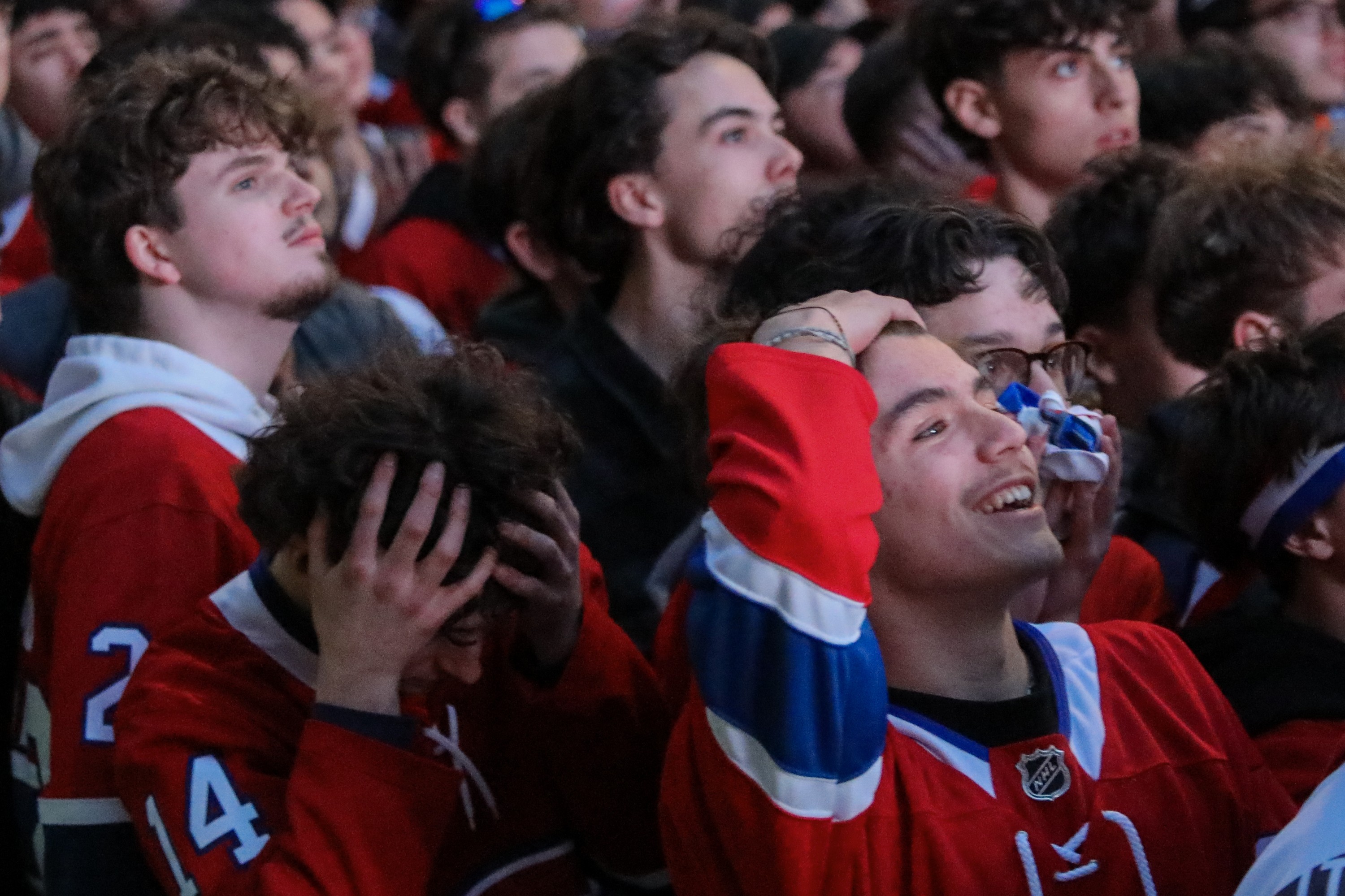 One fane puts his head in his hands while another runs his hand over his hair as the Canadiens lose 1-0 in OT.