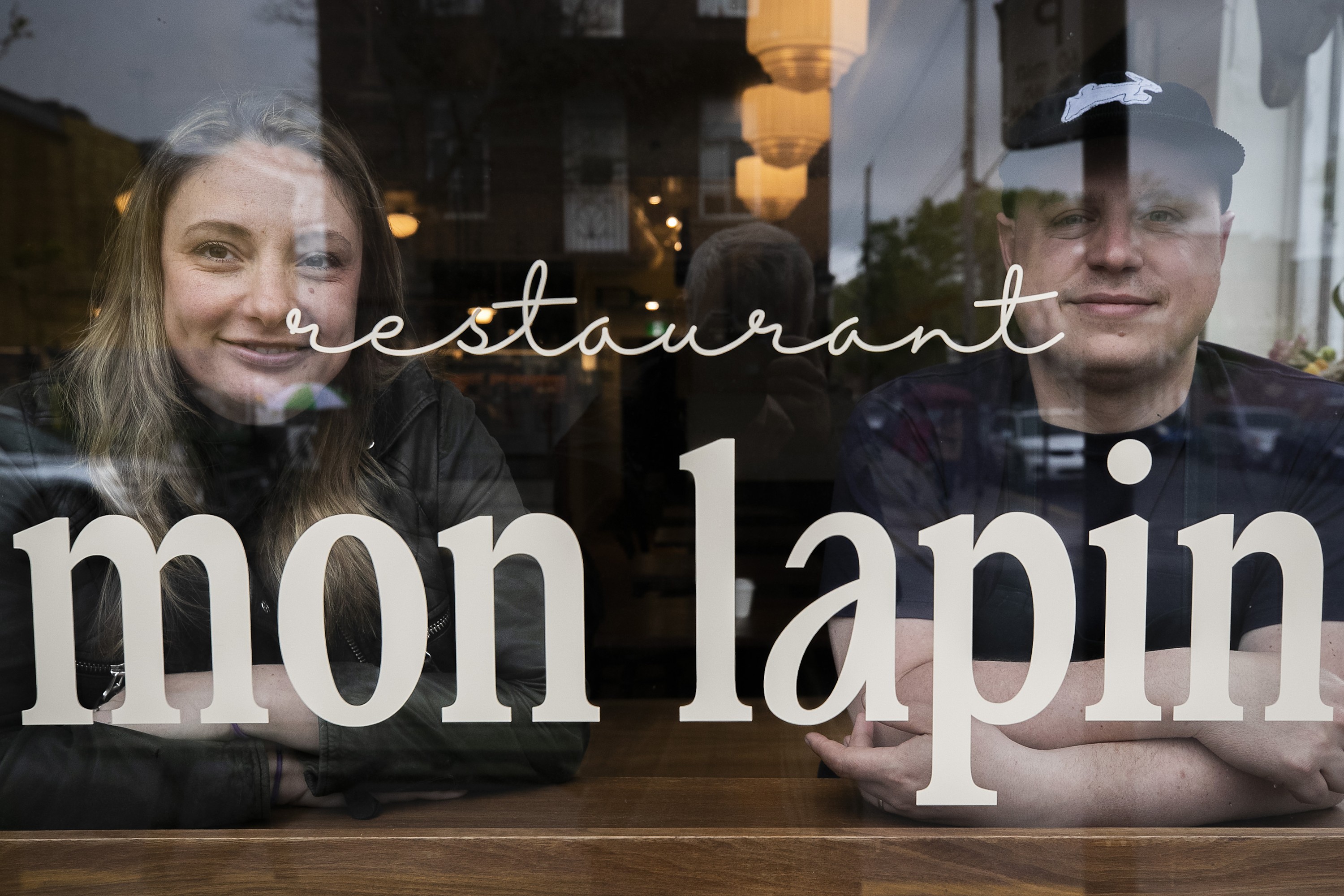 Mon Lapin chefs look out from the restaurant's front window.