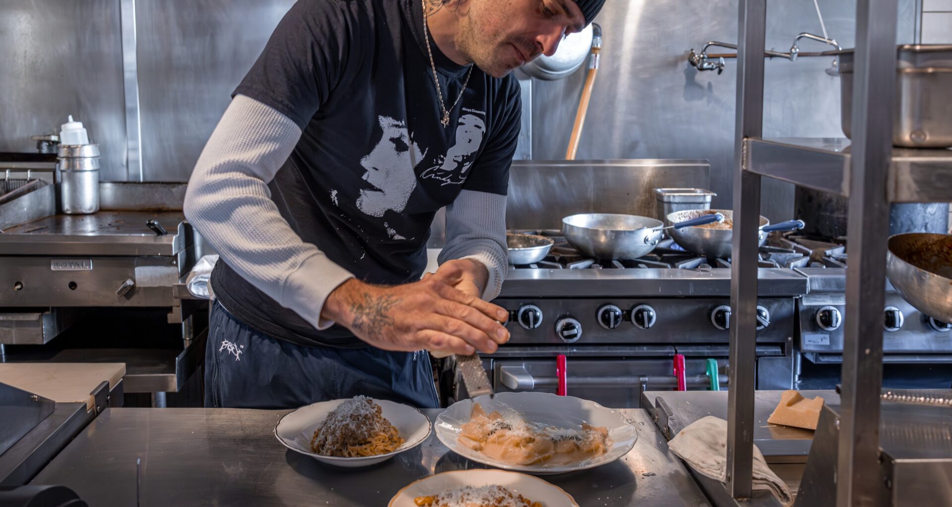 Pasta Pooks chef in the kitchen preparing plates.