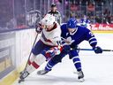 Sammy Blais of the Laval Rocket (left) gets past Henry Thrun of the Toronto Marlies during Game 4 of an AHL playoff series on May 5, 2026 in Toronto. Blais had two goals in Laval's 4-0 win.