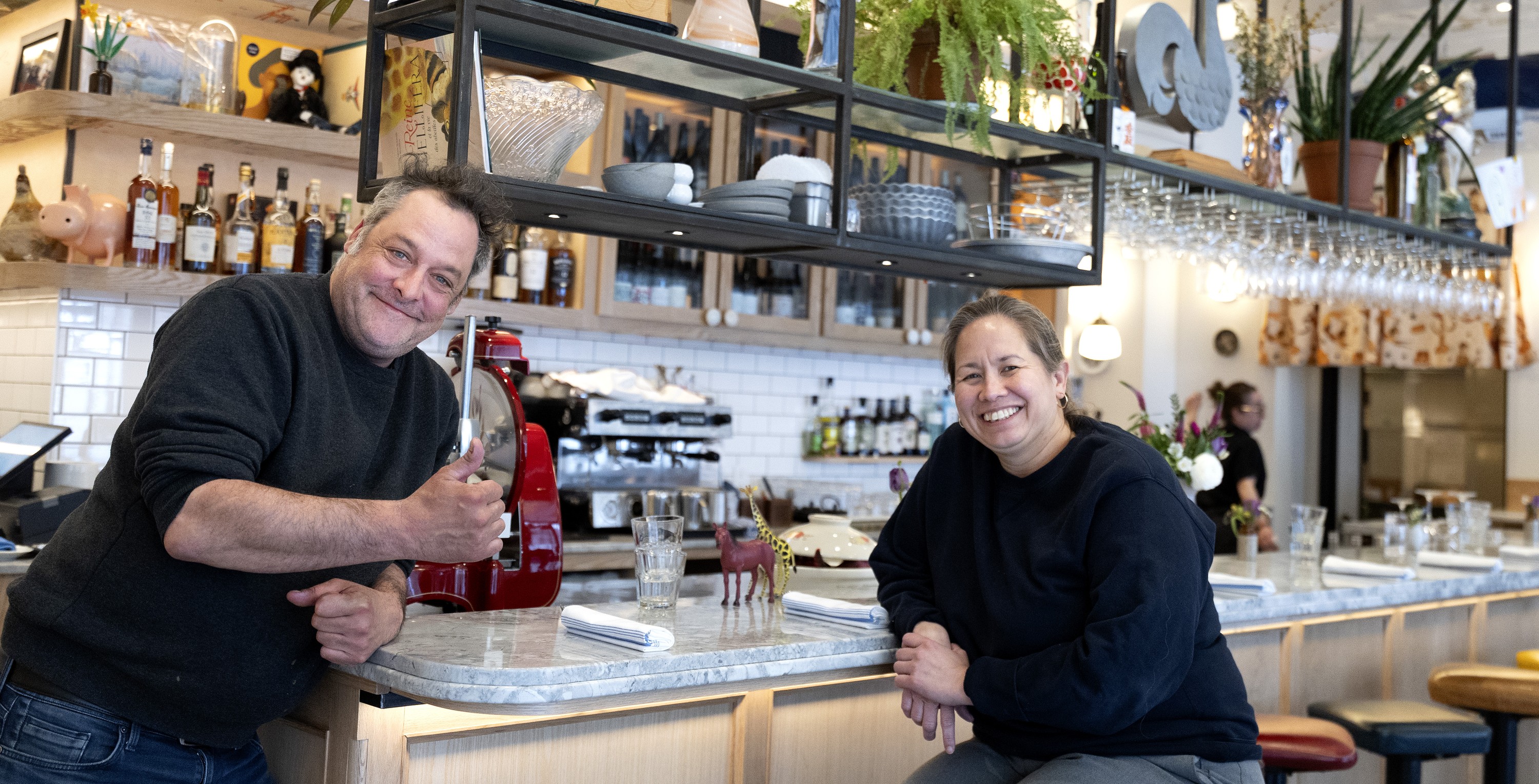 Juliette Plaza chefs and co-owners smiling in the dining room of their restaurant.