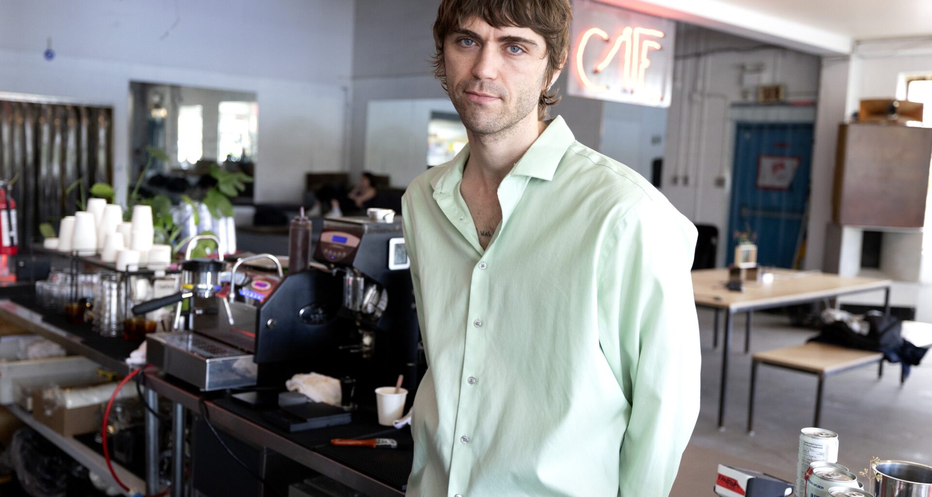 A man stands in a café.
