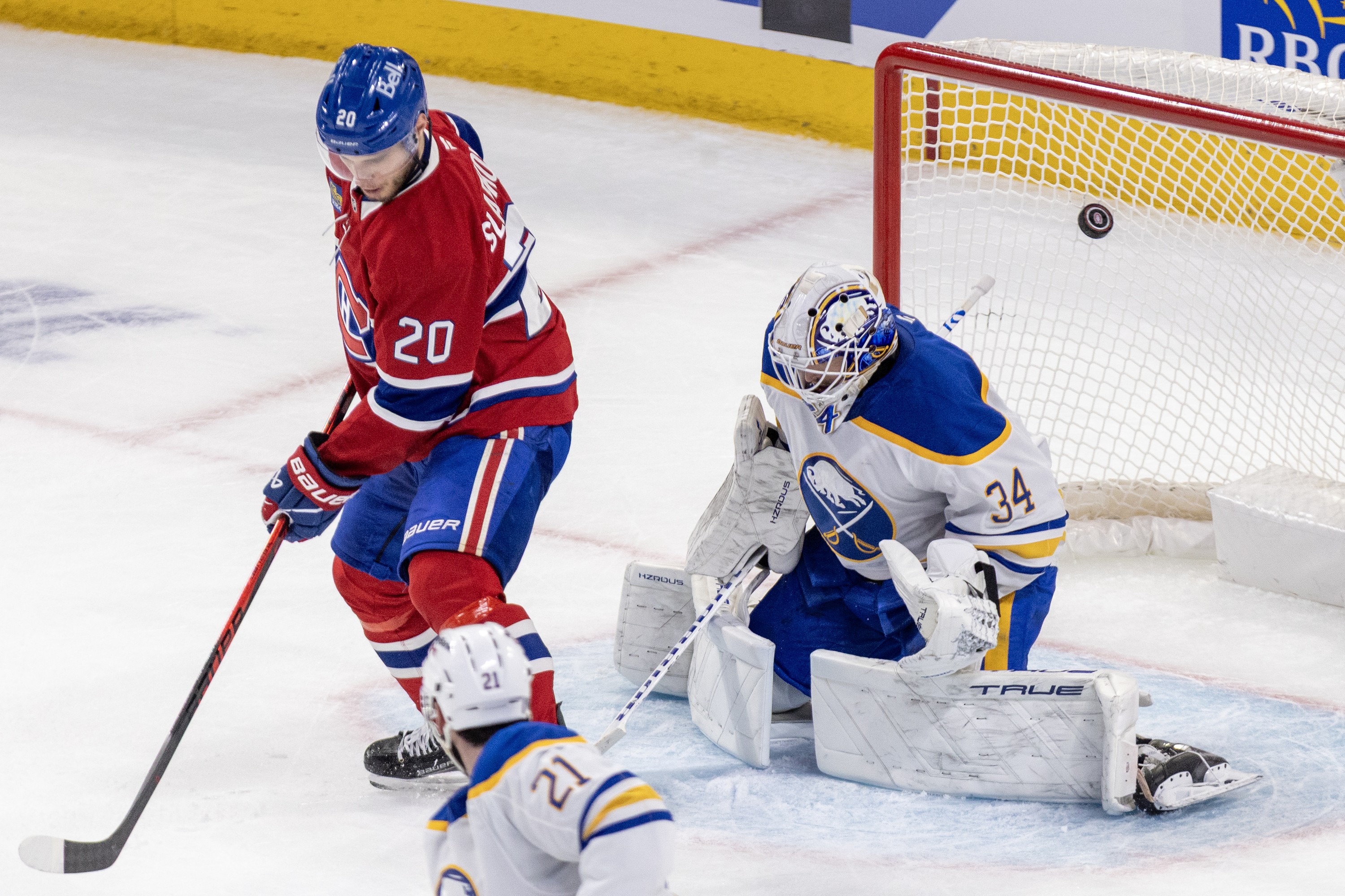 Montreal Canadiens' Juraj Slafkovsky deflects the puck past Buffalo Sabres' Alex Lyon.