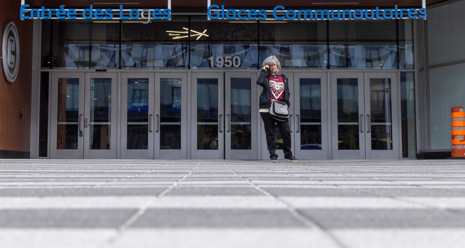 Fan stands outside Place Bell