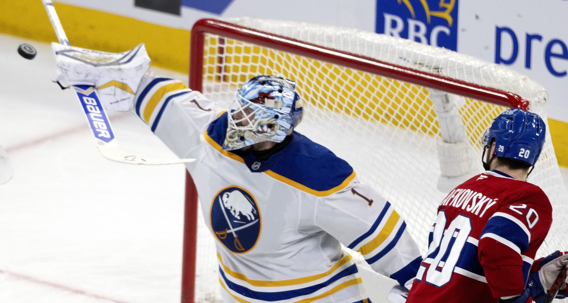 Canadiens left wing Juraj Slafkovsky (20) watches Buffalo Sabres goaltender Ukko-Pekka Luukkonen (1) deflect the puck