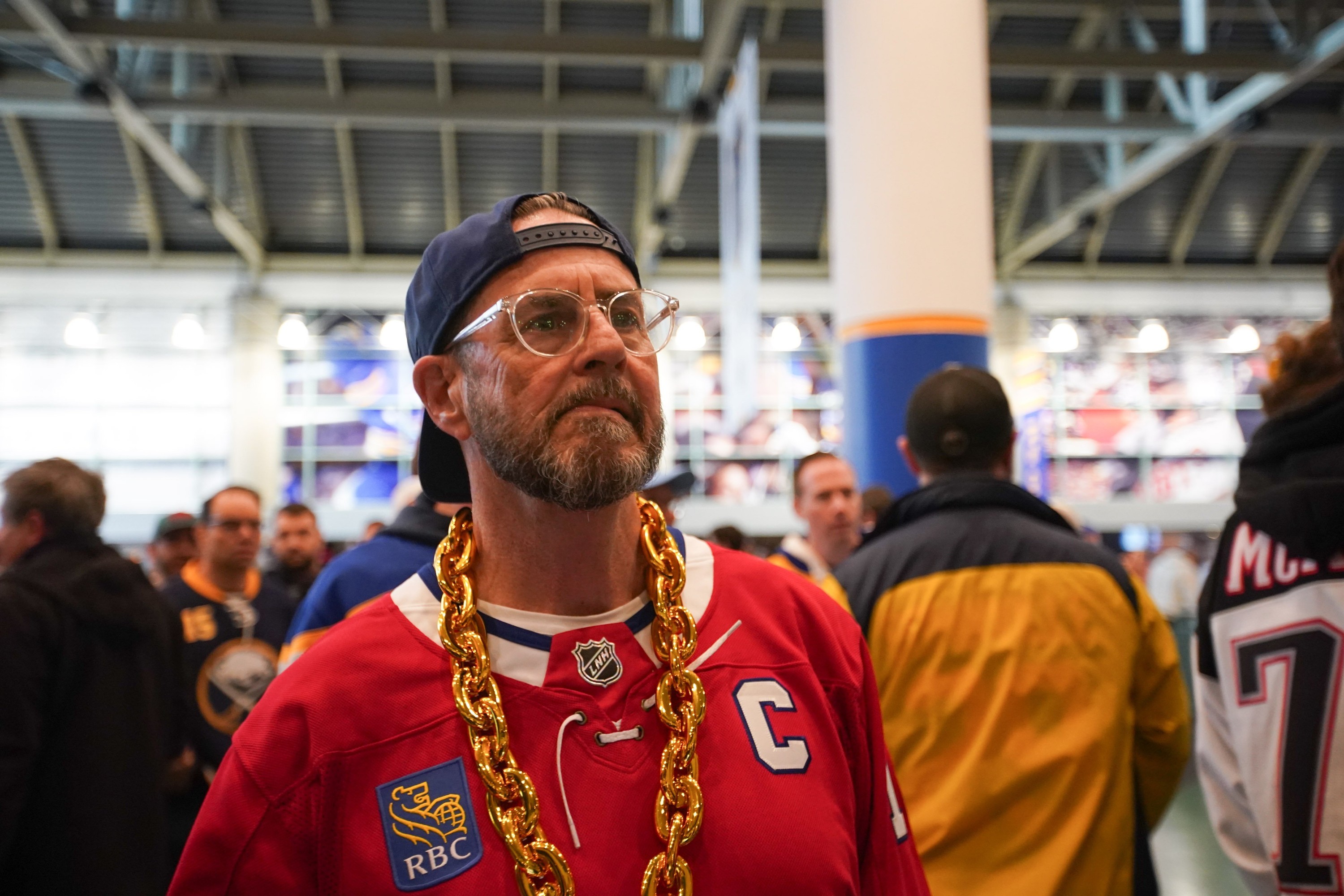 Man wearing large, plastic gold chain and Montreal Canadiens jersey