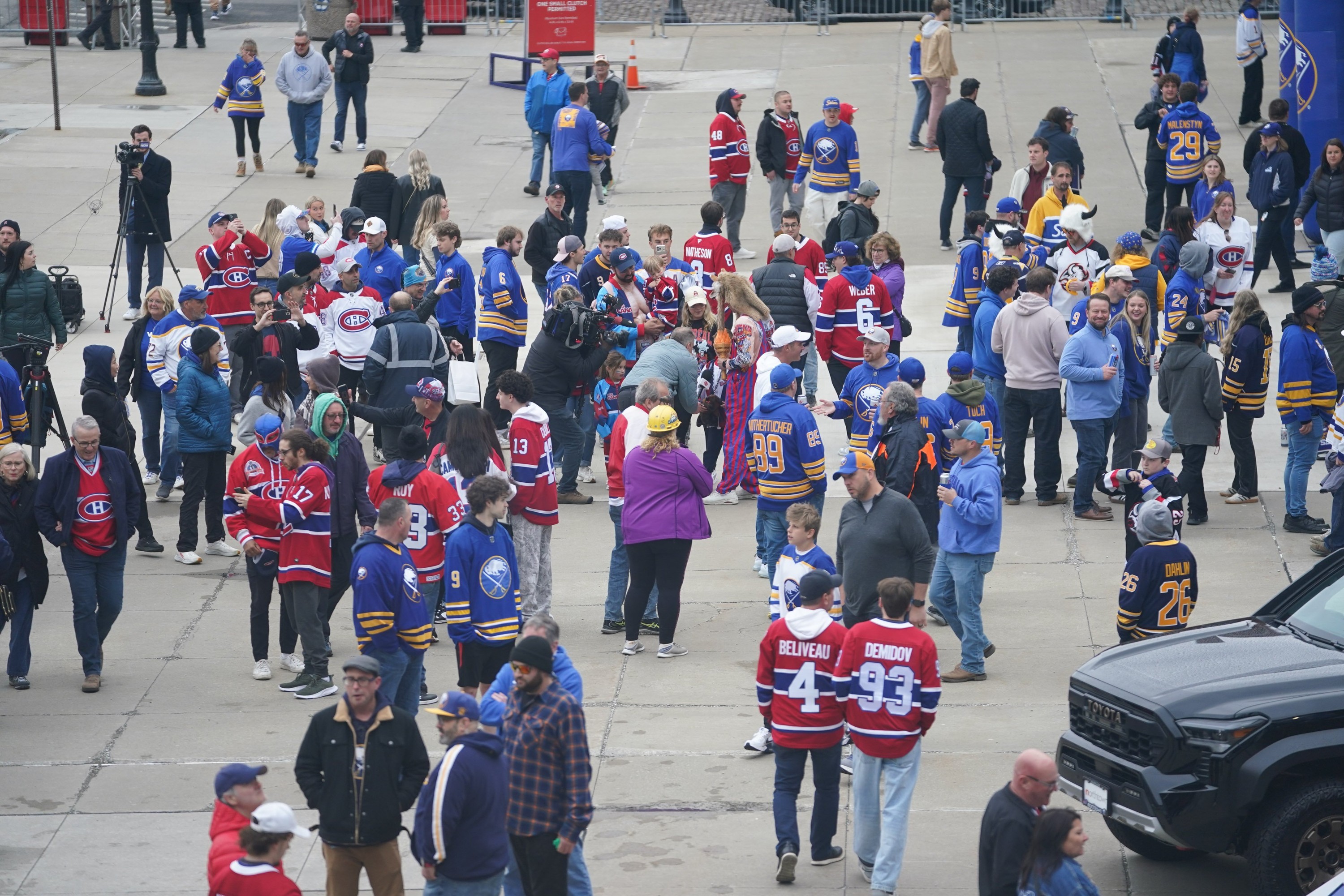 Crowd of hockey fans in Canadiens and Sabres jerseys