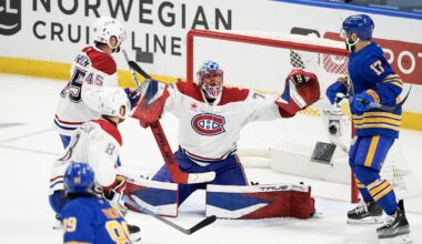 Hockey goaltender stretches wide to make a save.