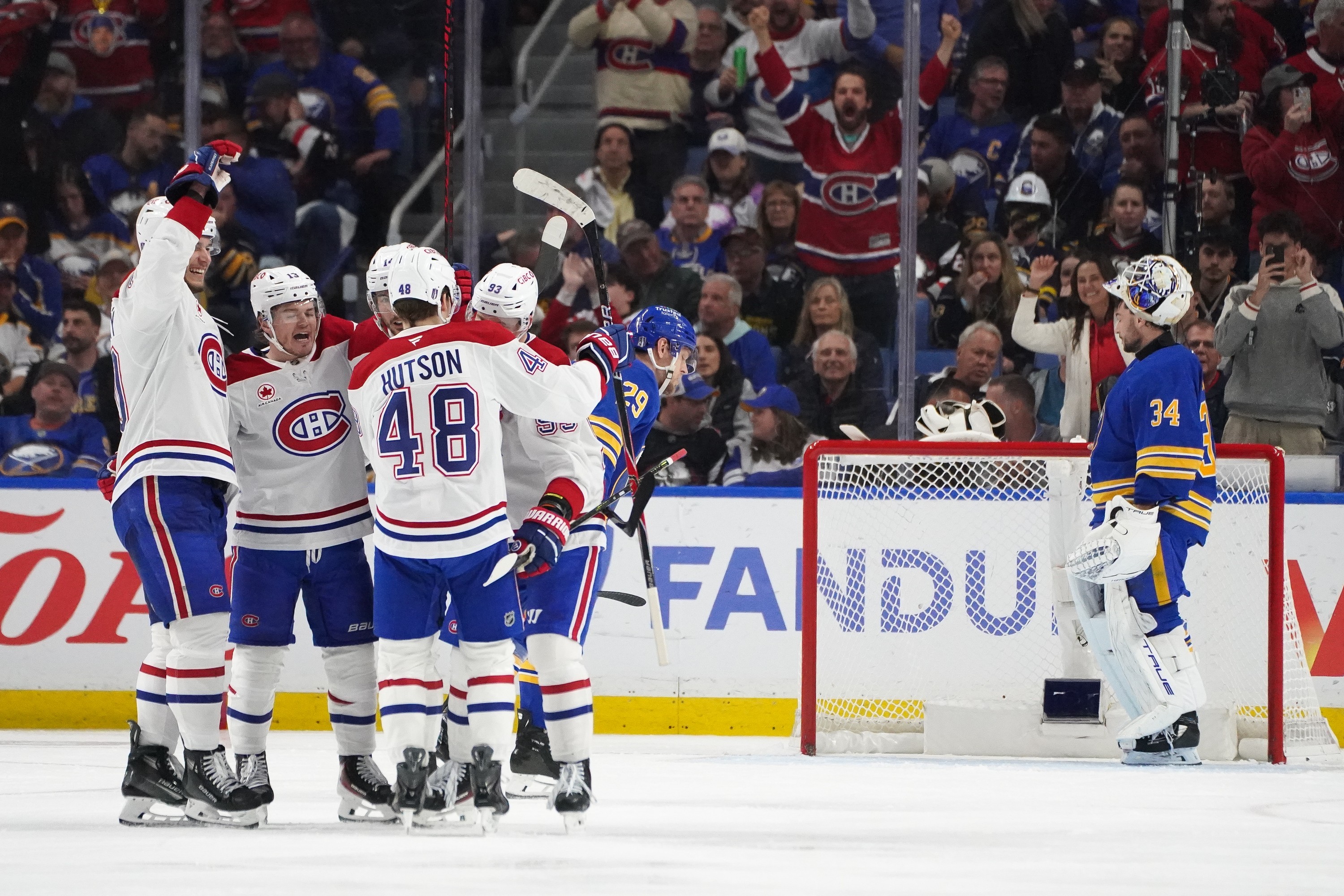 Canadiens players on top power-play unit celebrate Ivan Demidov's third-period goal with a group hug.
