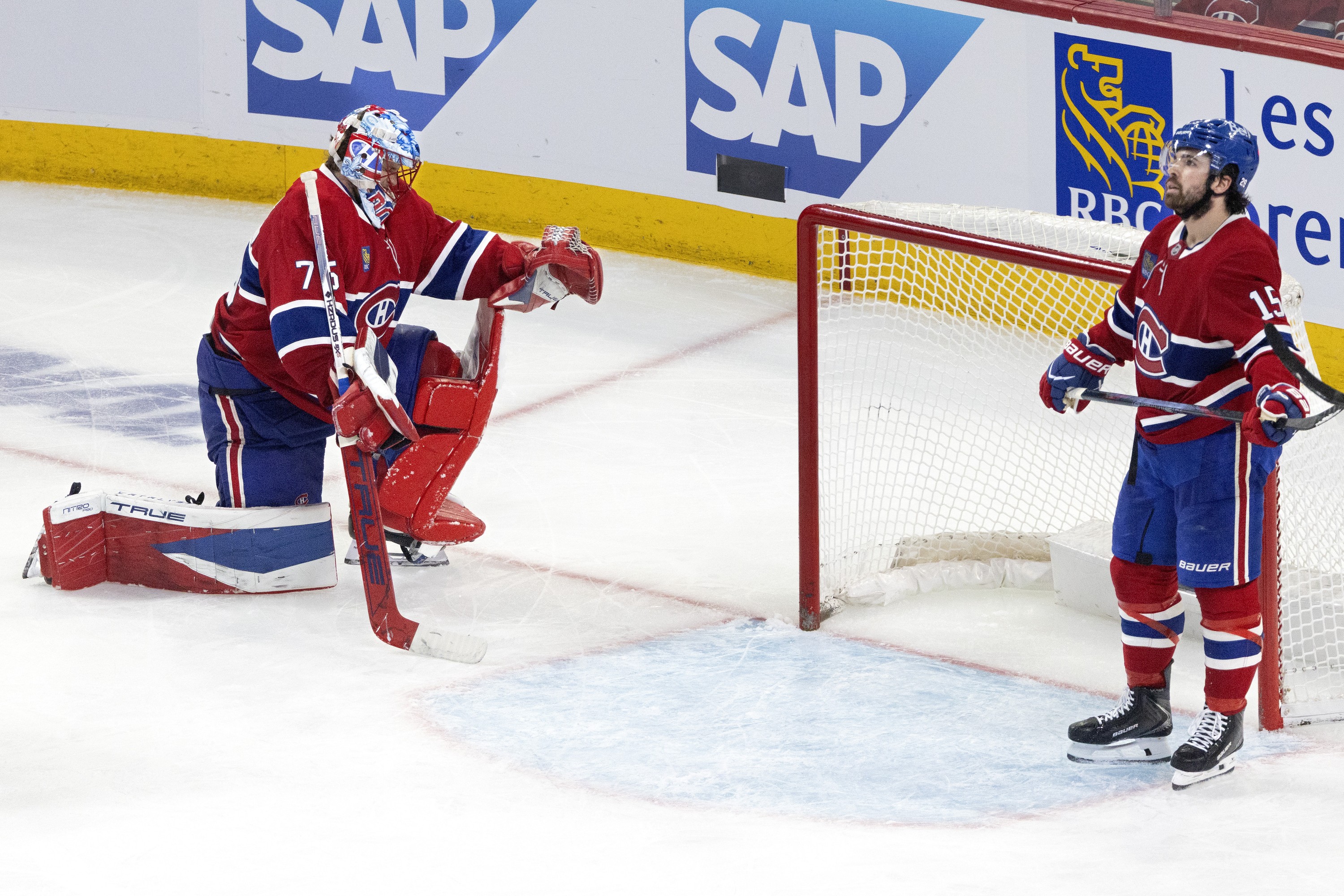 Montreal Canadiens goaltender Jakub Dobes and Canadiens centre Alex Newhook react to an unseen goal by the other team.