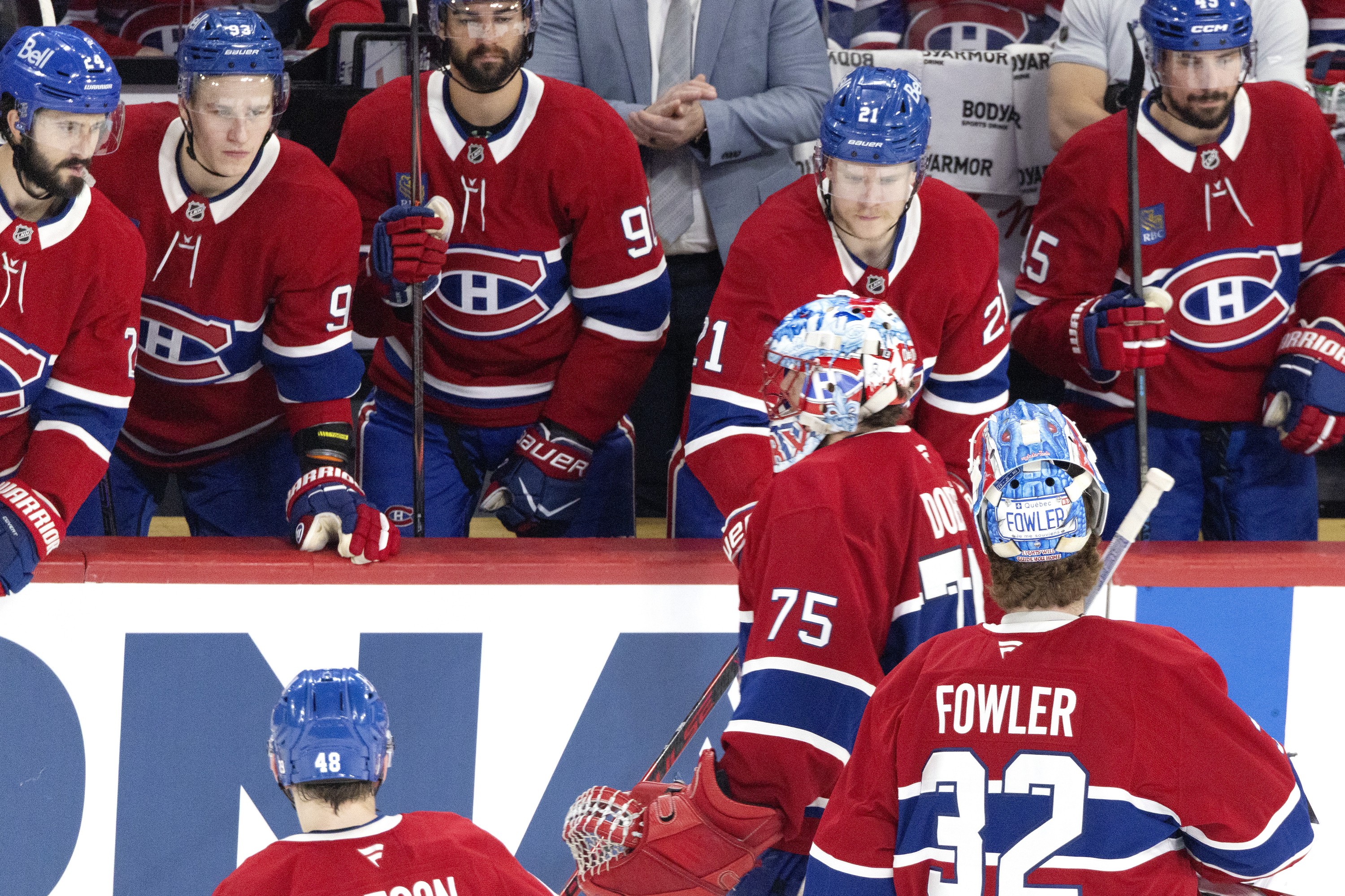 Hockey goaltender gets pulled from the game as his backup heads to the net.