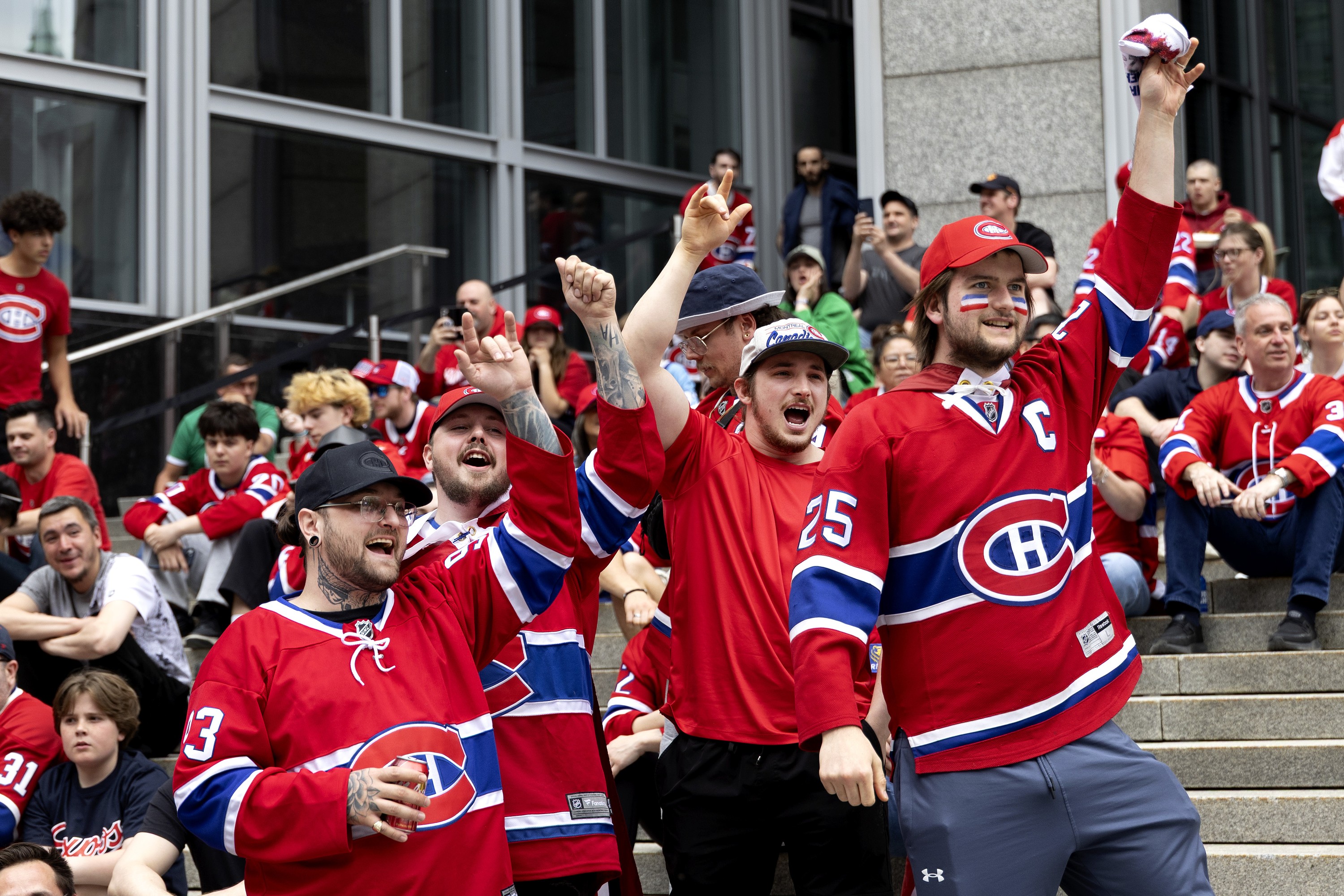 Canadiens fans cheer as the big outdoor screens are lit. 