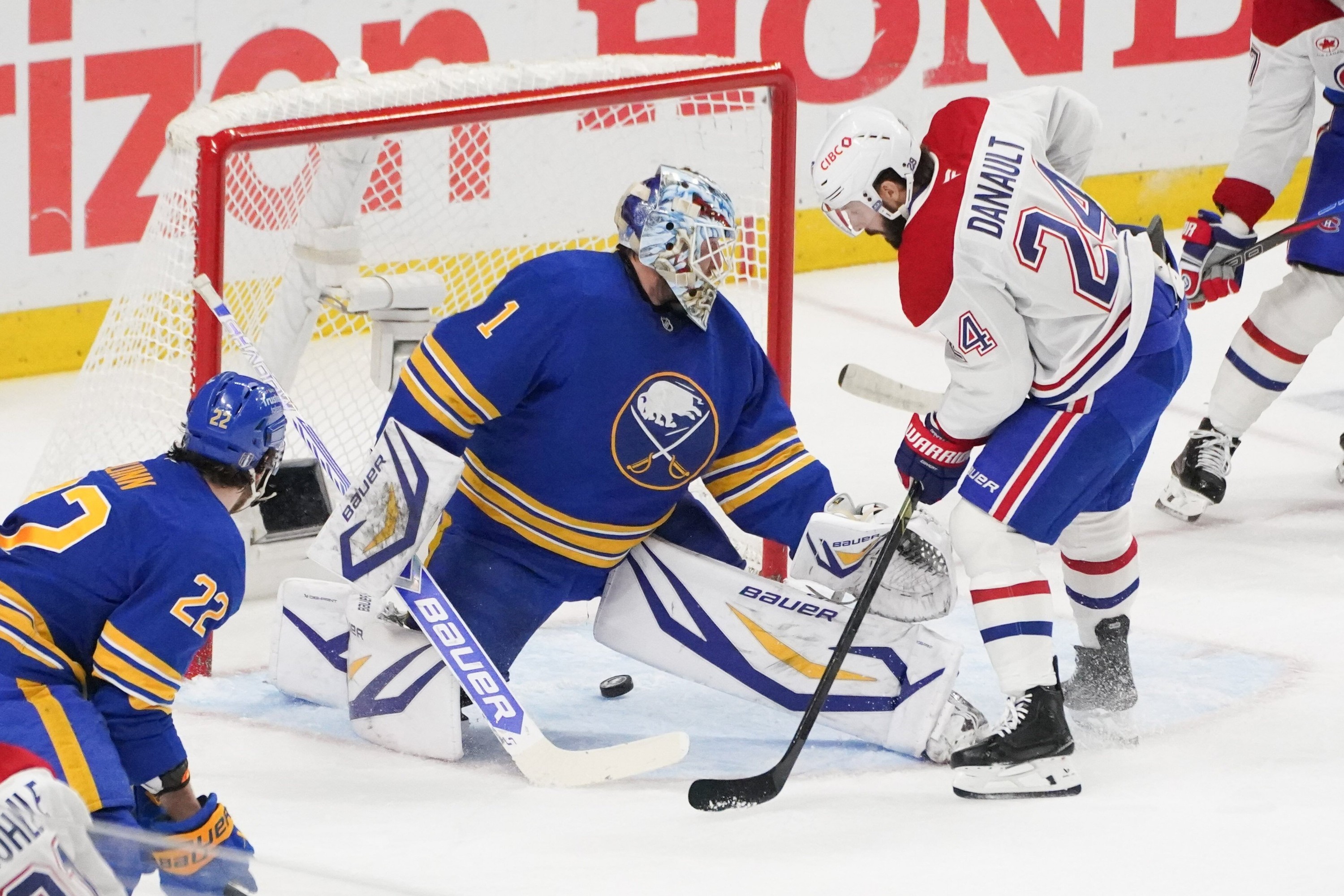 The puck goes five-hole under Buffalo Sabres goaltender Ukko-Pekka Luukkonen as Canadiens' Philip Danault is in front of him