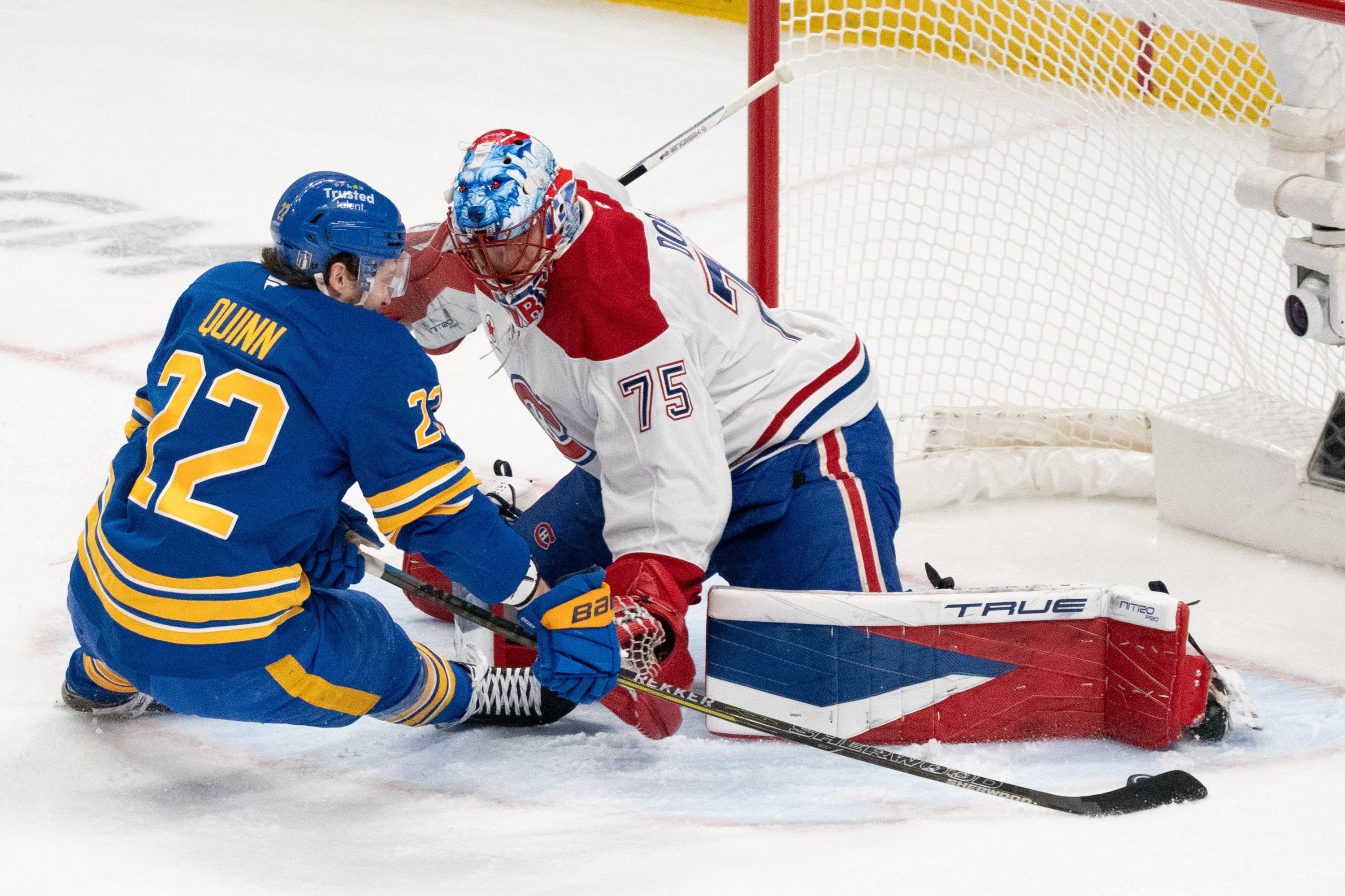 Canadiens goaltender Jakub Dobes (75) stops Buffalo Sabres right wing Jack Quinn