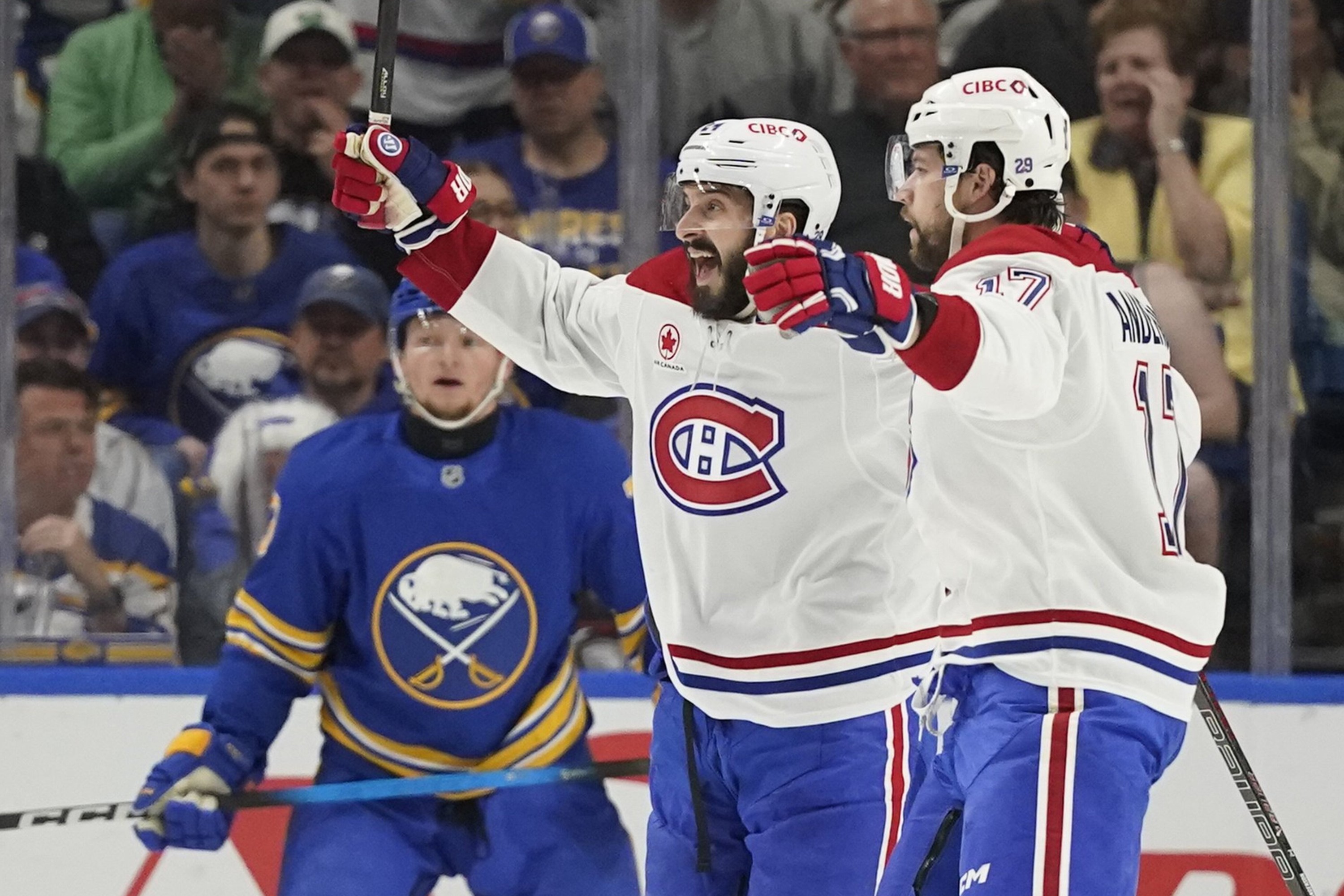 Canadiens' Philip Danault cheers on the ice next to teammate Josh Anderson.