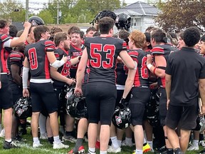 Cornwall Wildcats huddle, celebrating a win
