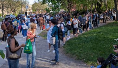 People wait in long lines outside.