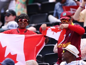 Canada fans show their support with flags during the ICC Men's T20 Cricket World Cup in 2024.