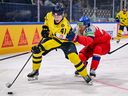 Sweden's forward Ivar Stenberg battles against a Czech defender at the IIHF Ice Hockey Men's World Championship in May.