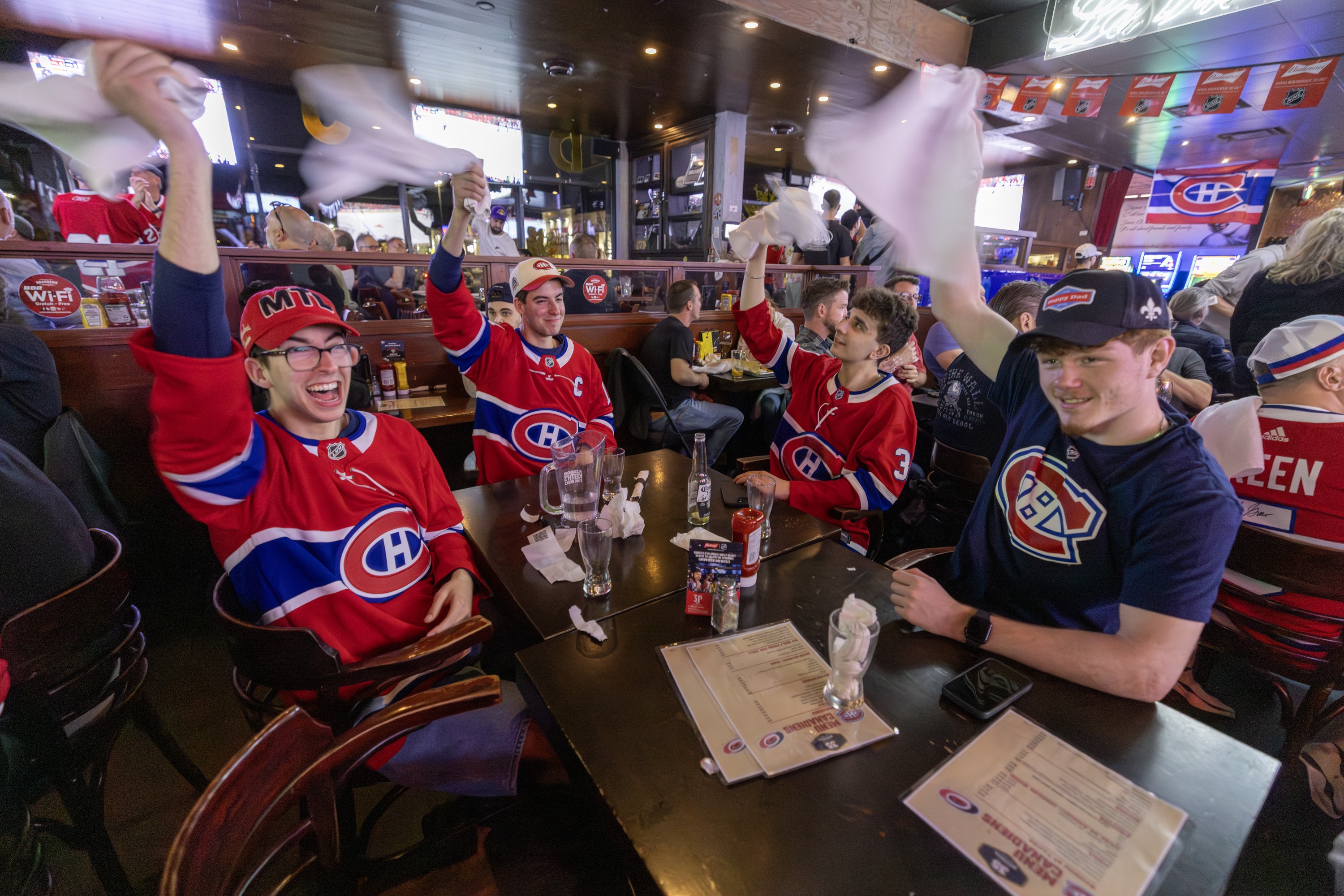 Canadiens fans, from left, Matteo Eljarrat and his brother Massimo, with Joey Vaccaro and Cohen Steele celebrate after watching the Habs beat the Carolina Hurricanes in Game 1 of Eastern Conference final at Brasserie des Rapides in LaSalle on Thursday night.