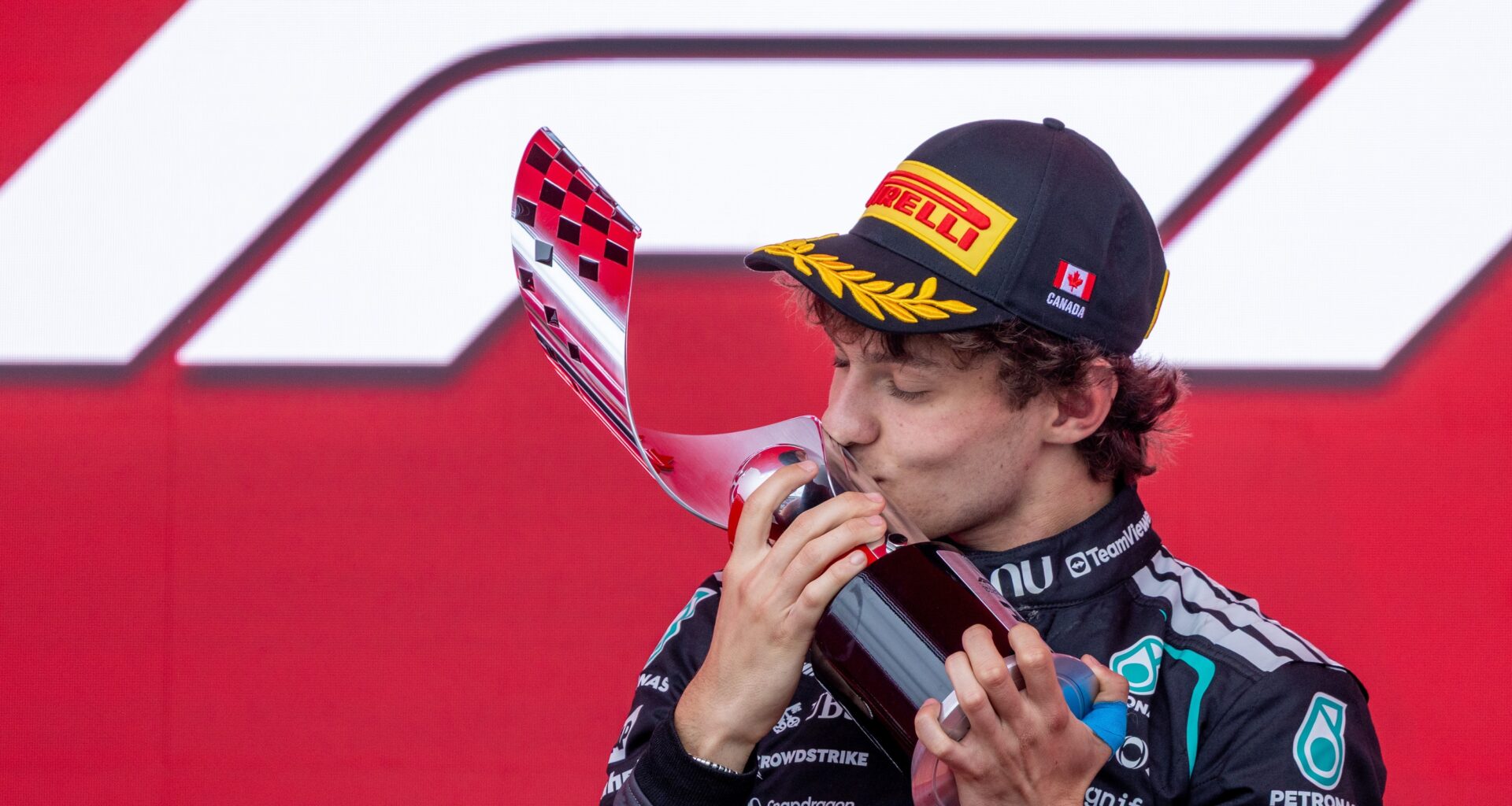 Mercedes driver Kimi Antonelli kisses his trophy after winning the Canadian Grand Prix.