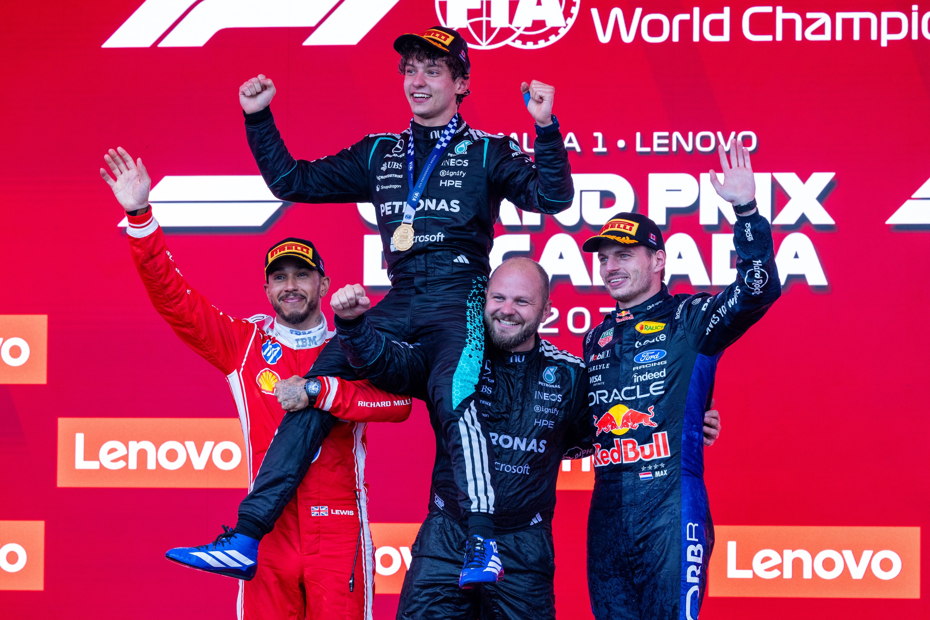 Mercedes driver Kimi Antonelli is lifted onto the shoulders of Ferrari driver Lewis Hamilton and Dean Hale, Mercedes senior race team technician, and Red Bull Racing driver Max Verstappen as they celebrate on the podium at the Canadian Grand Prix.