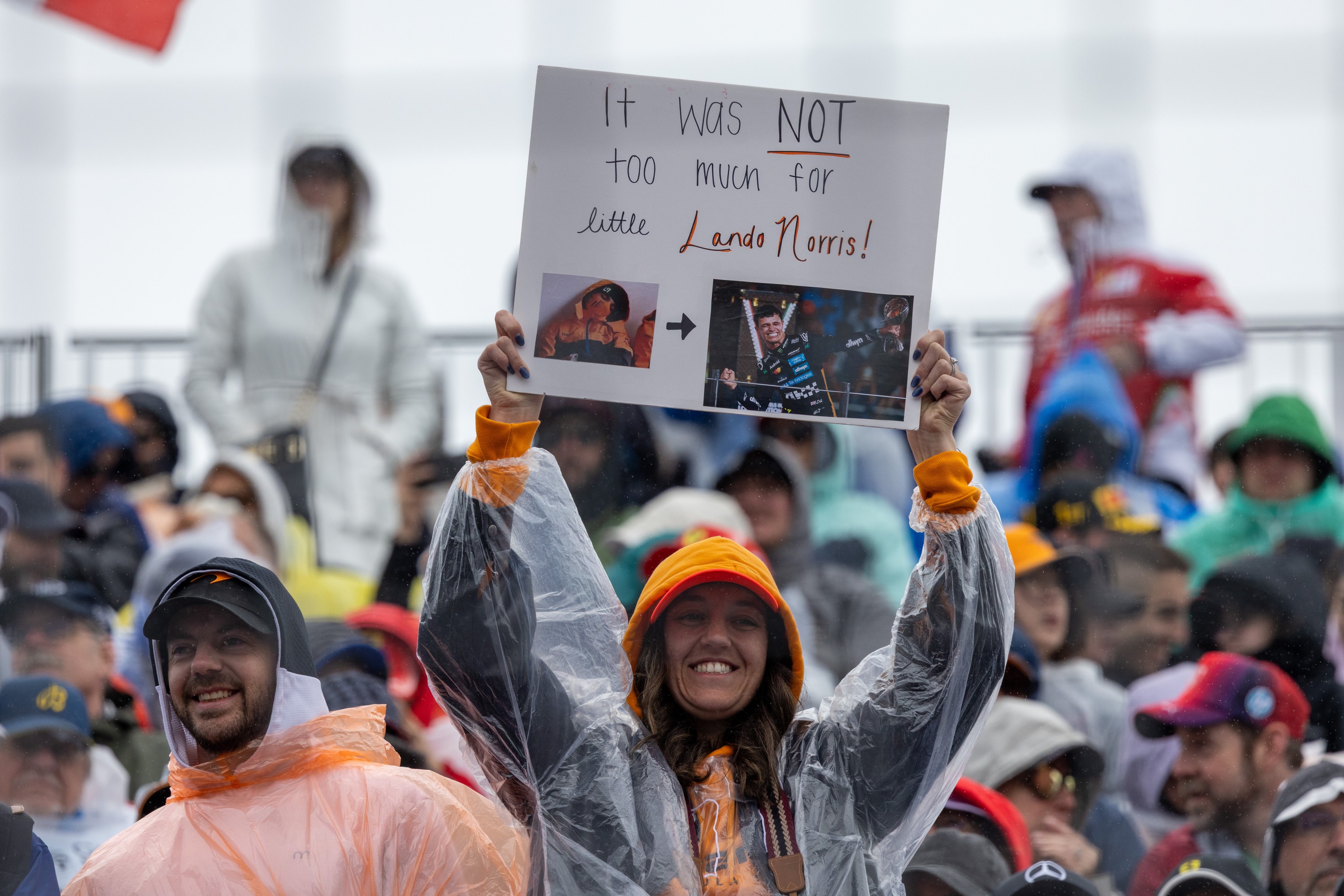 A fan in a rain poncho shows off a sign in support of Lando Norris at the Canadian Grand Prix.