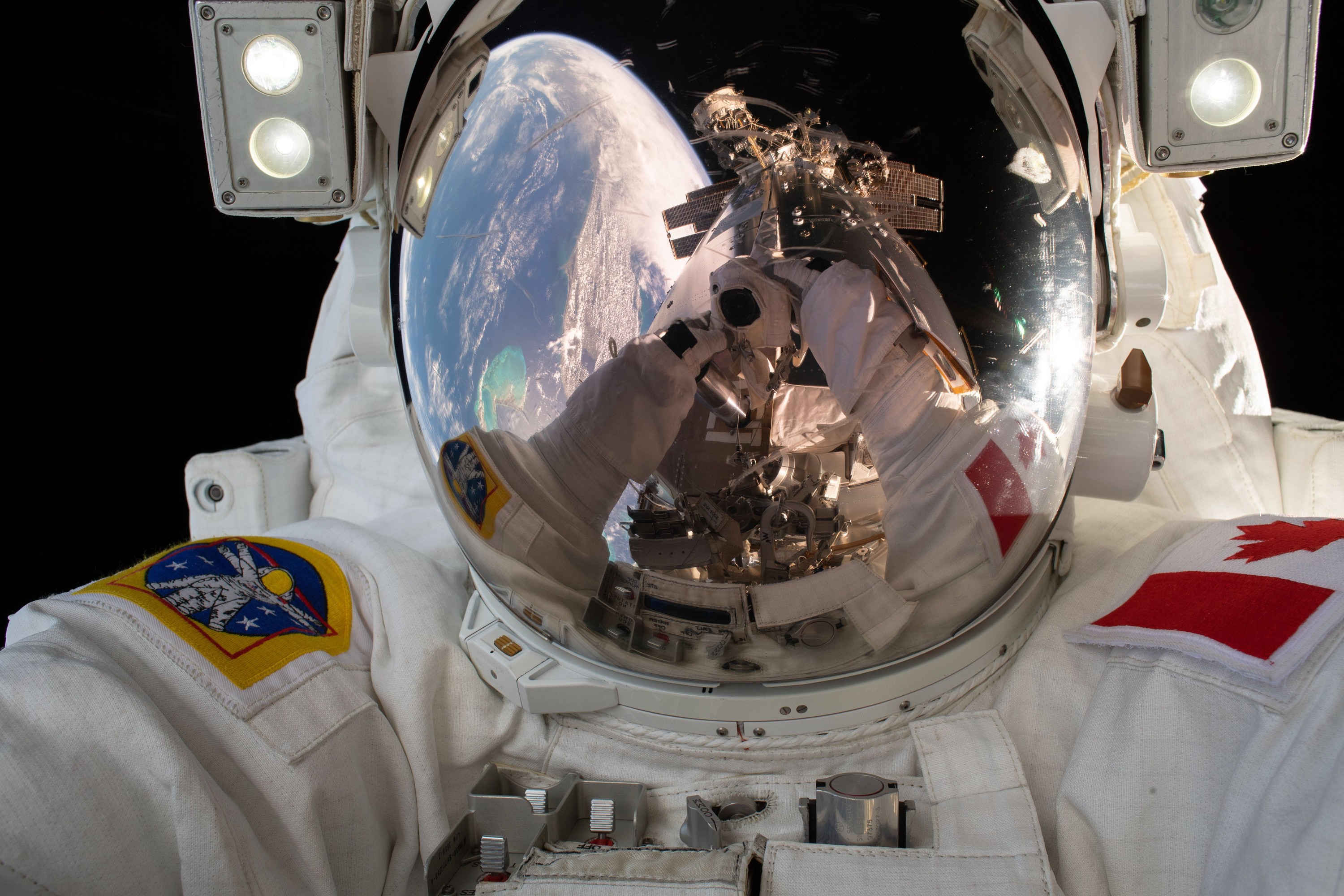 Astronaut takes a self-portrait while performing a spacewalk.