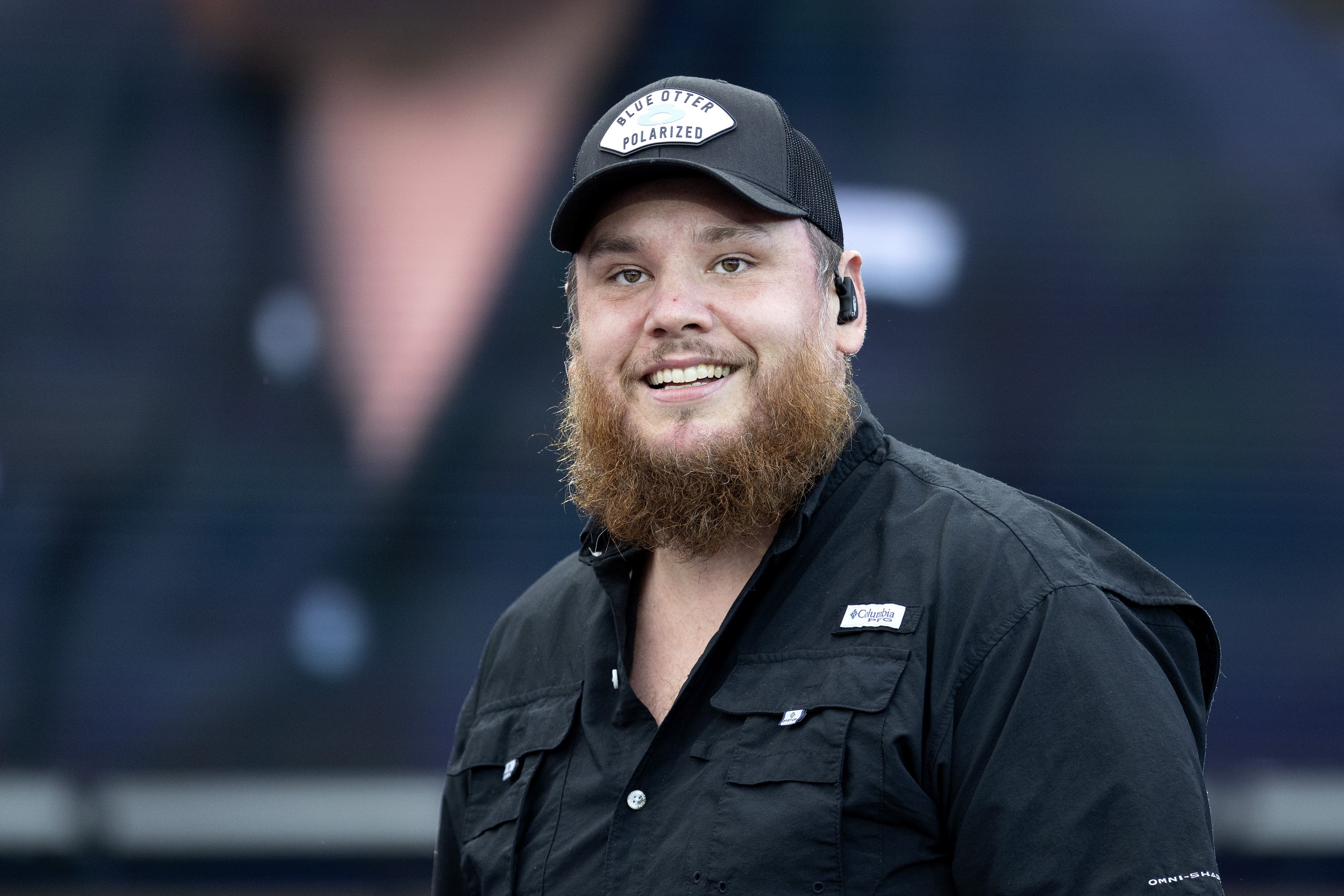 Musician smiles for his fans at concert.