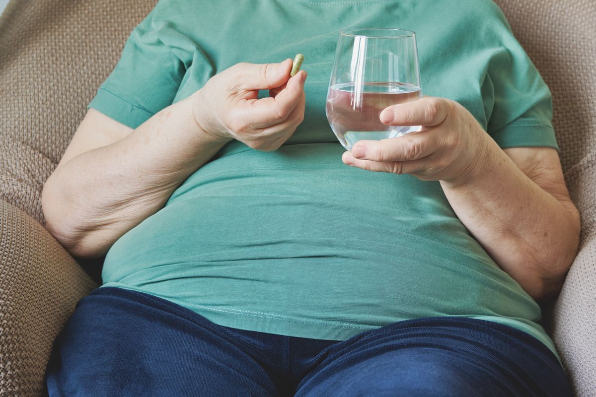 A woman taking weight loss pills