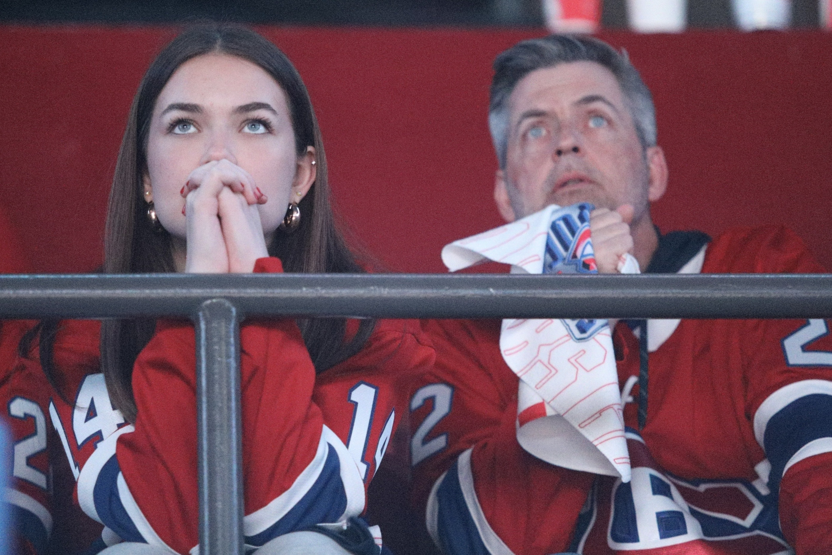 Two Canadiens fans watch a game intently