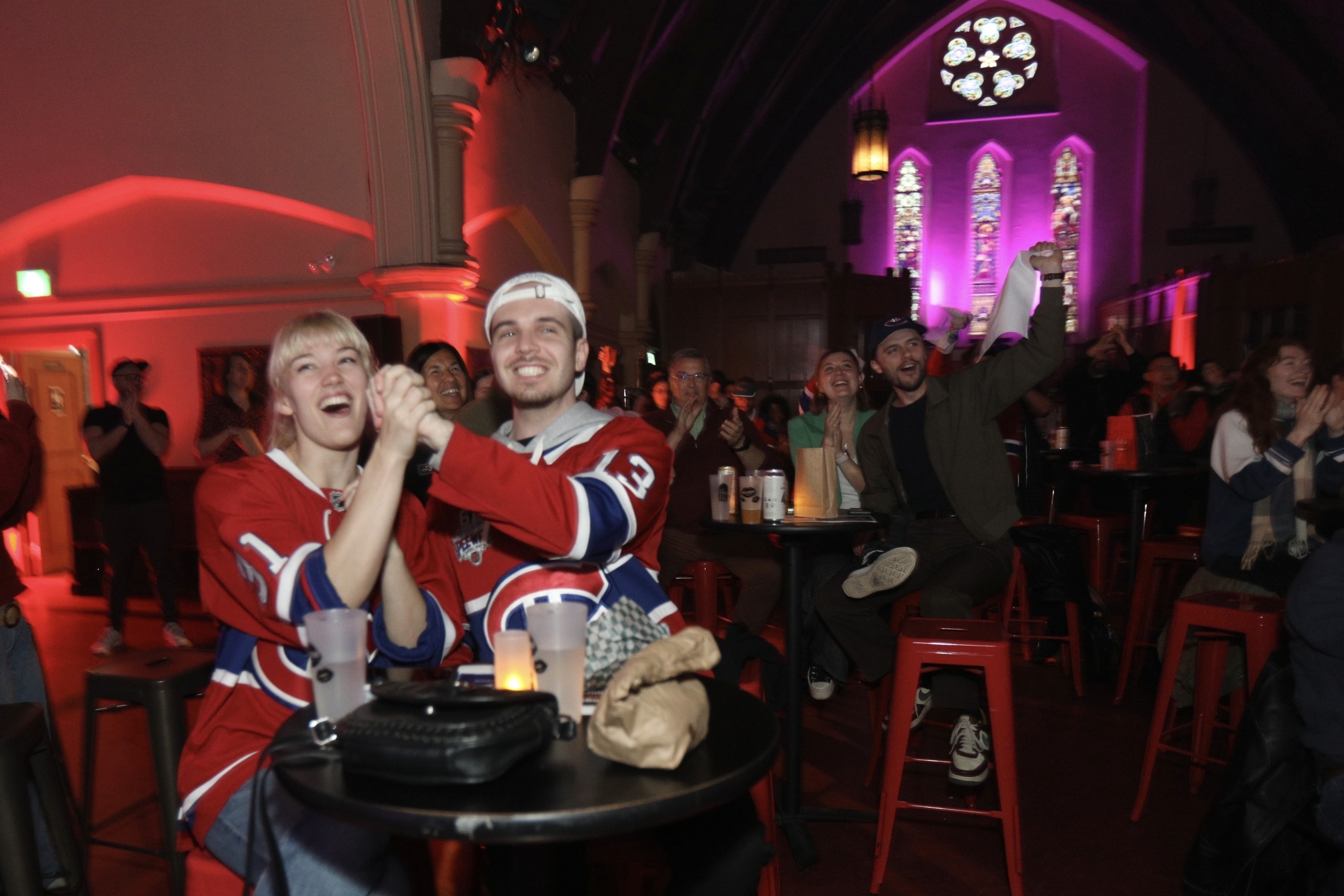 Man and woman in Canadiens jerseys cheering