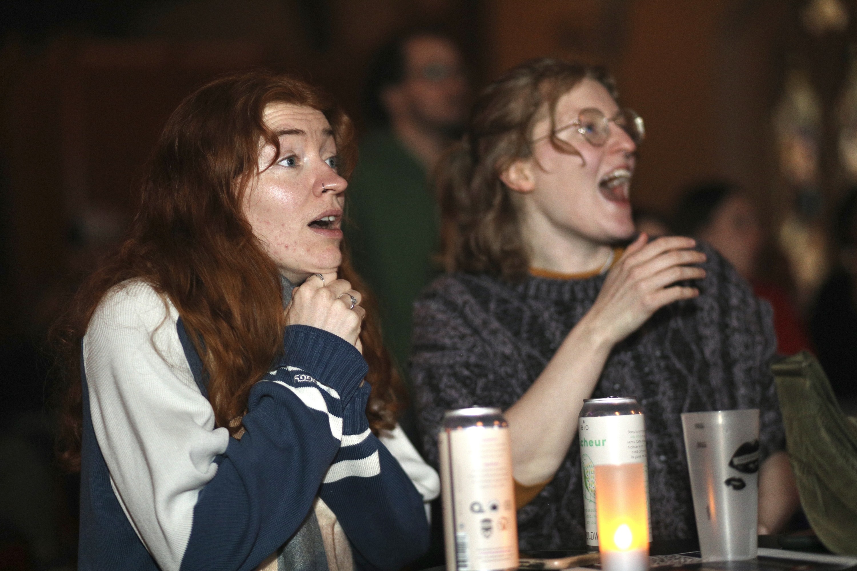 Two women watching hockey game