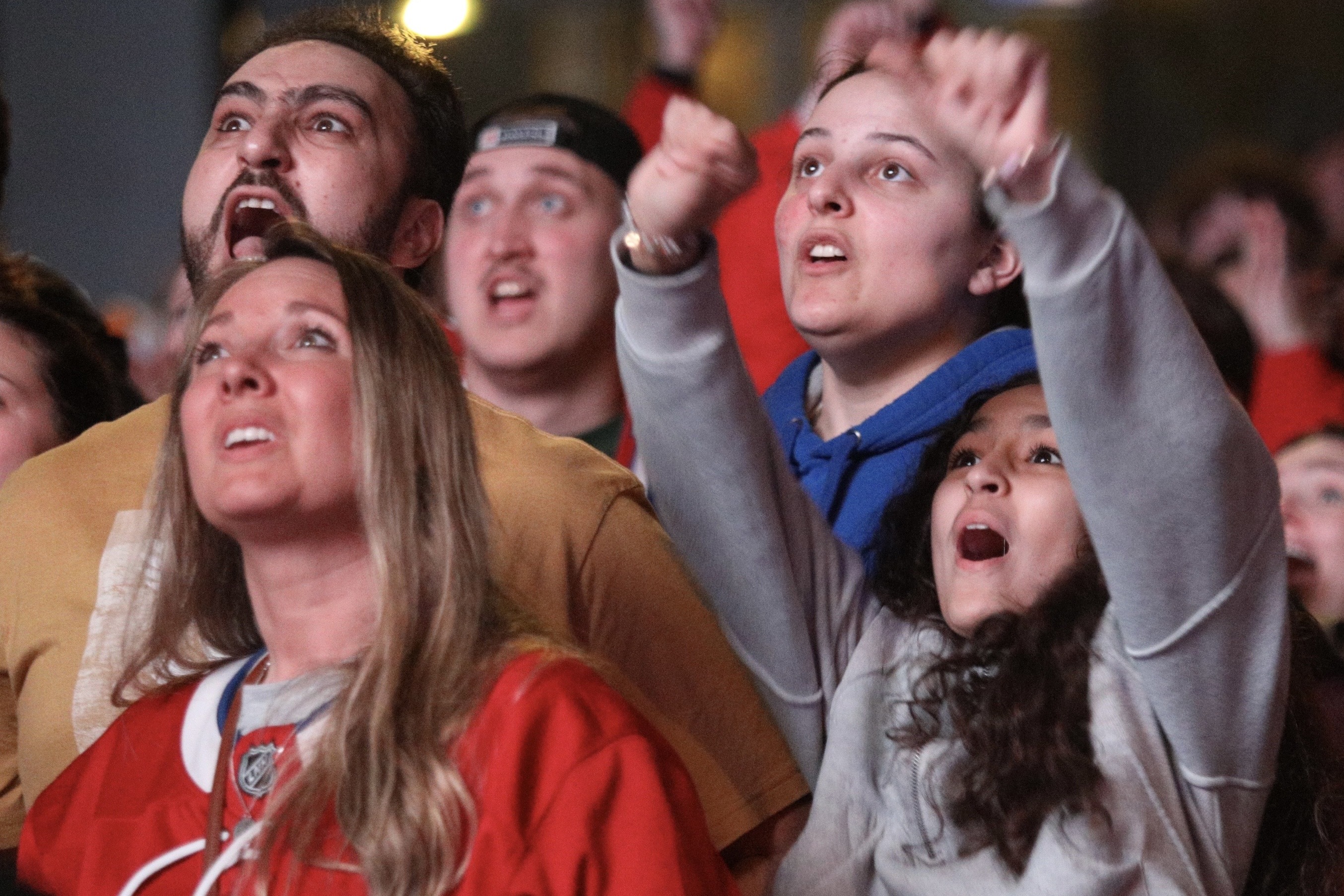 Montreal Canadiens fans react with a range of emotions at an outdoor watch party.