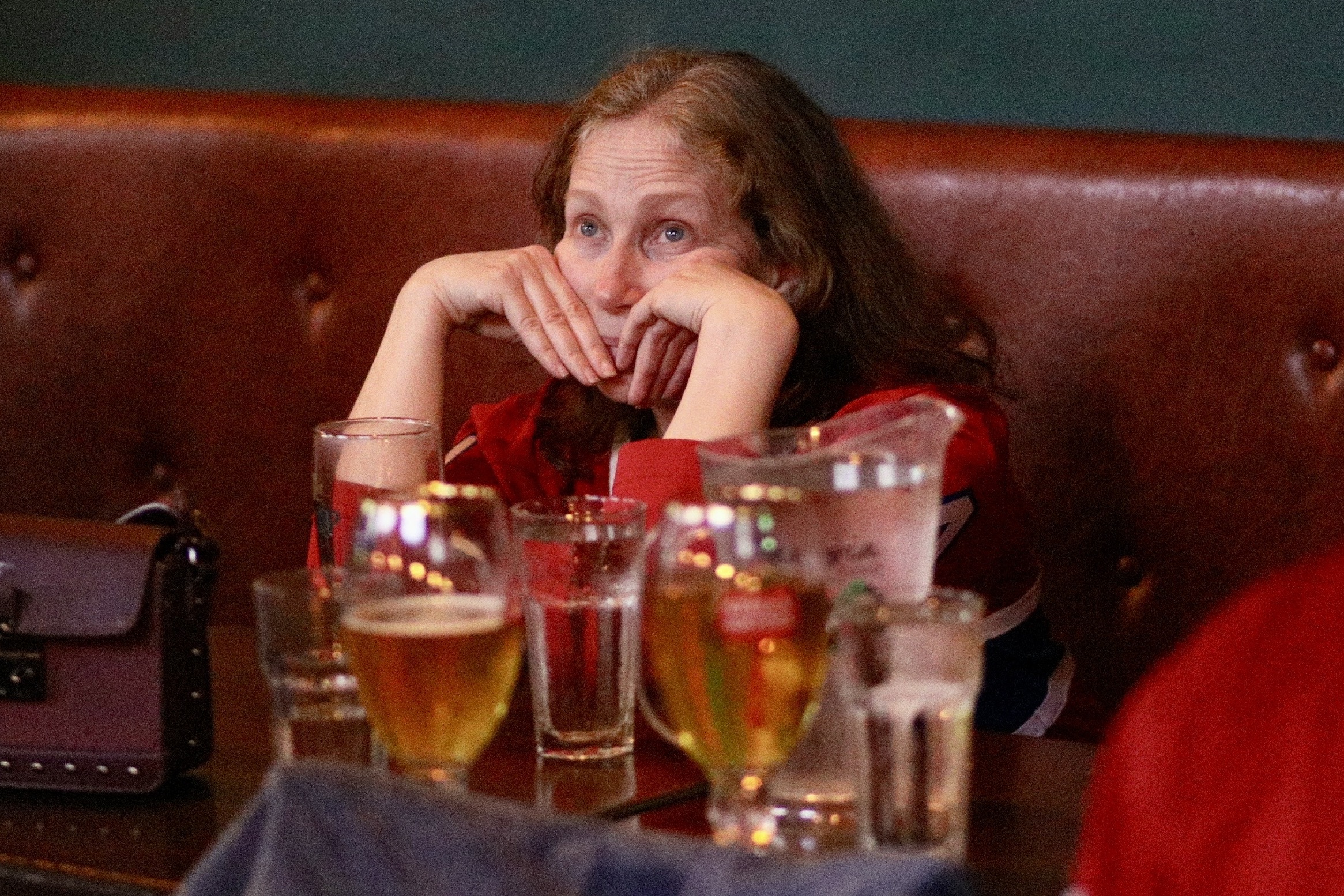 Hockey fan looks down in the dumps watching a game.
