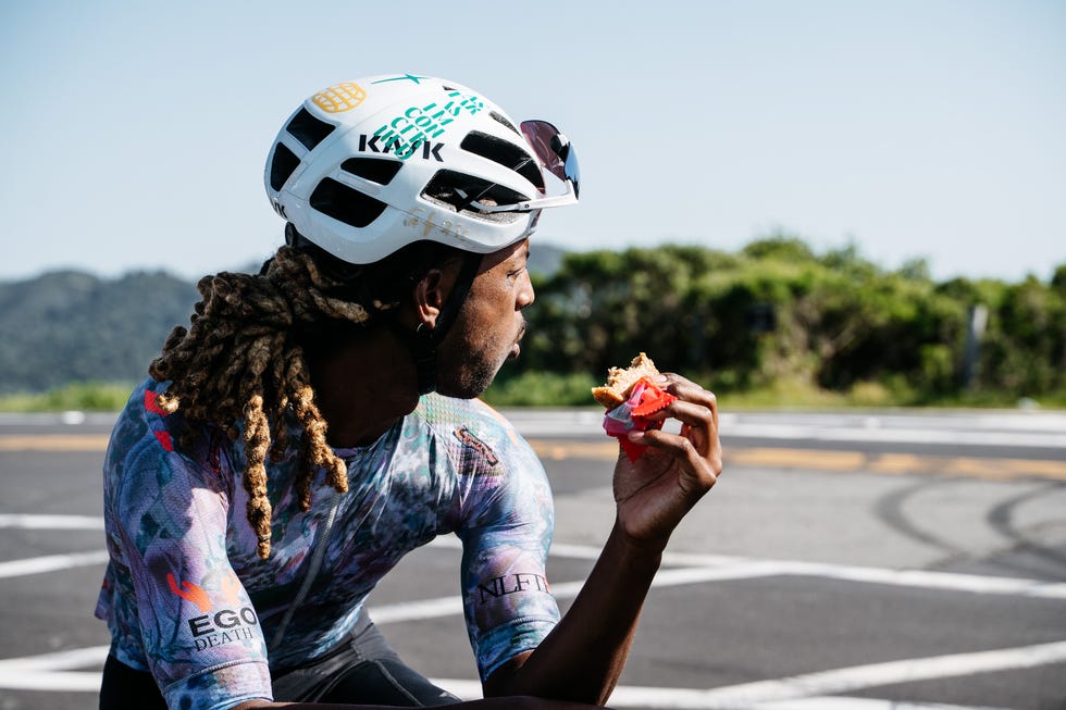 Cyclist resting and eating a snack. Cyclist resting and eating a snack.
