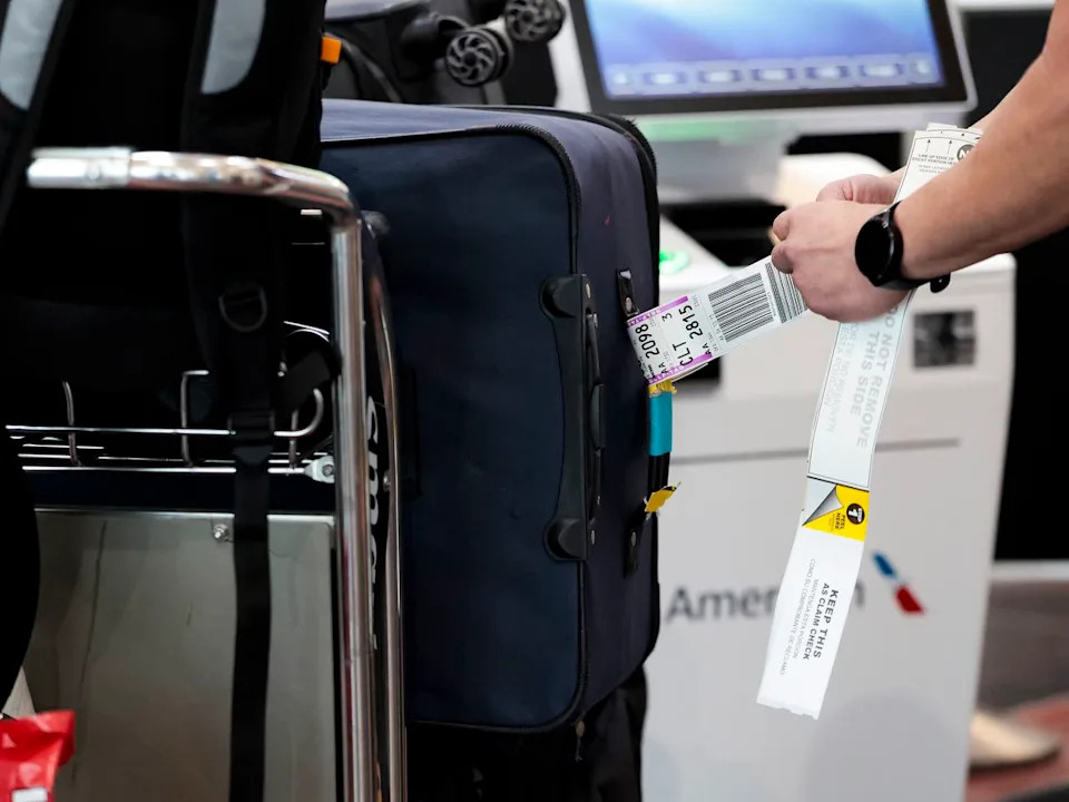 A traveller tags their bags before a flight on Dec. 23, 2025.