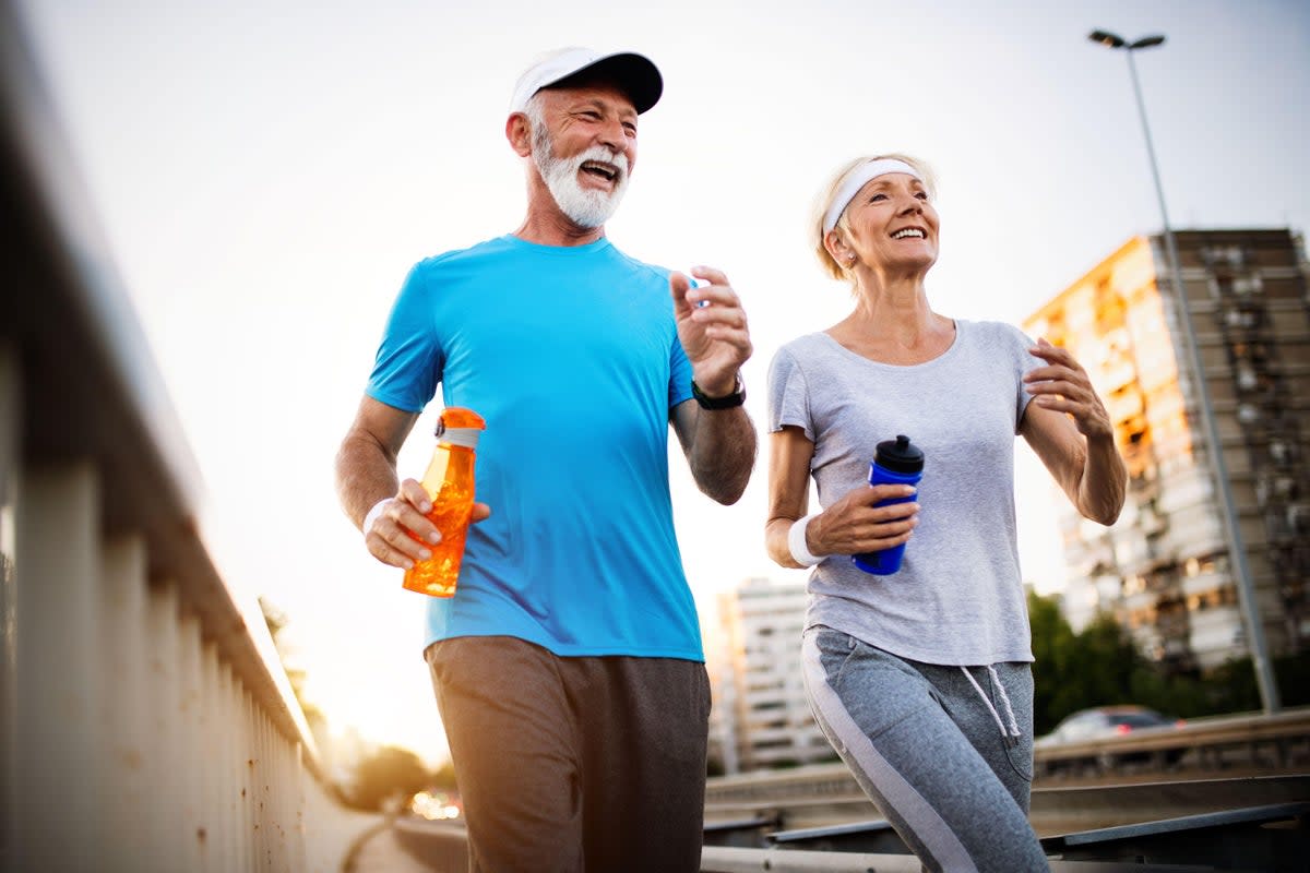 Senior couple running together (Alamy/PA) (Alamy/PA)