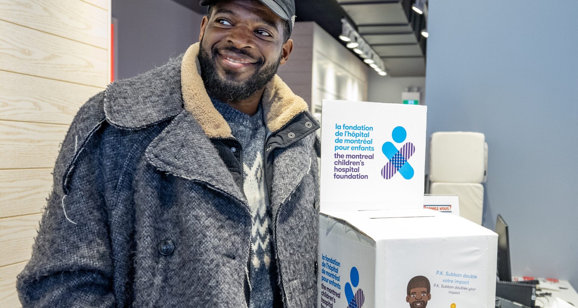 Former Canadiens star P.K. Subban picks up a box of cheques for the Montreal Children