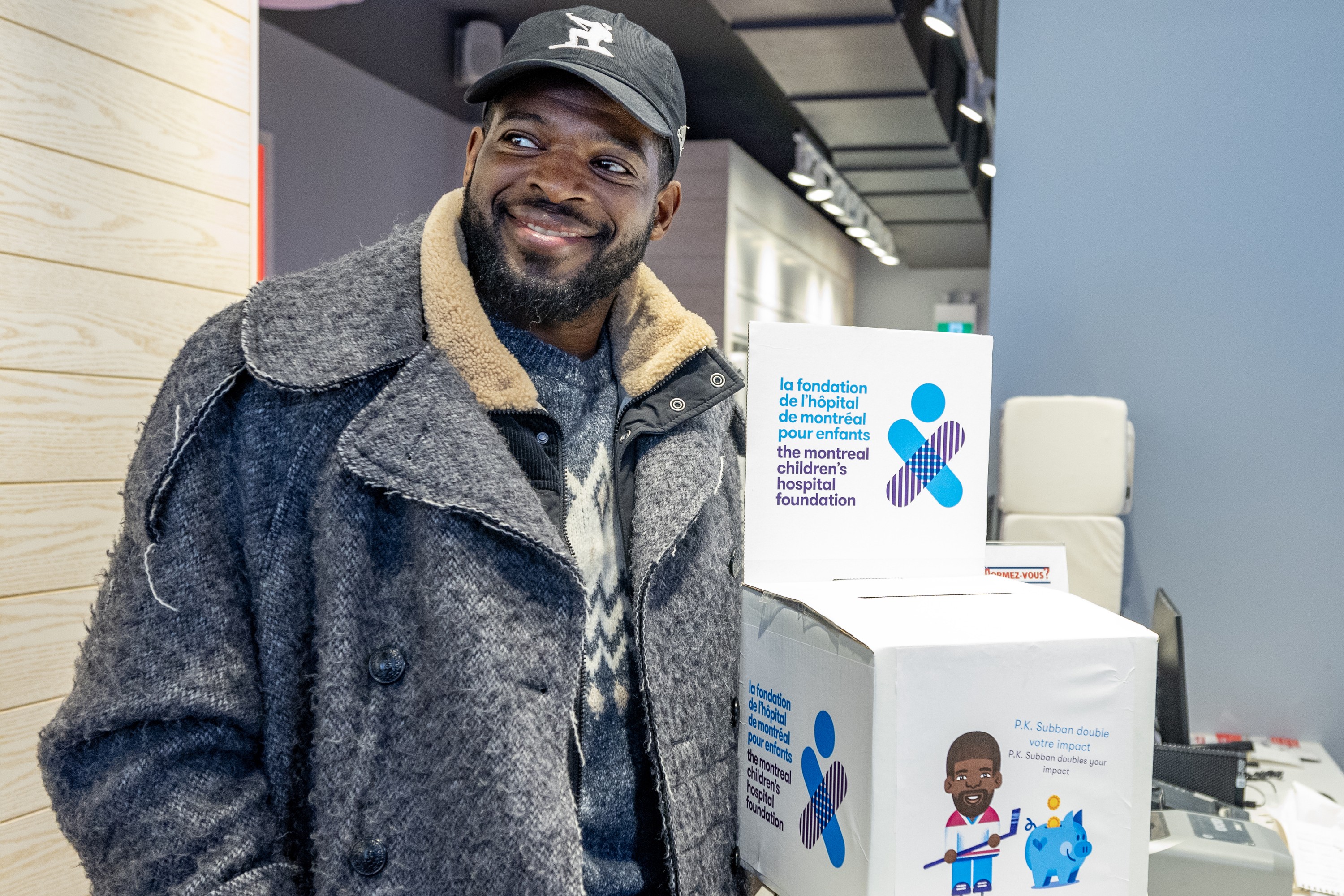 Former Canadiens star P.K. Subban picks up a box of cheques for the Montreal Children's Hospital Foundation.