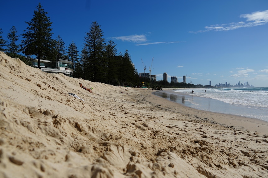 A long view along a beach from ground level.