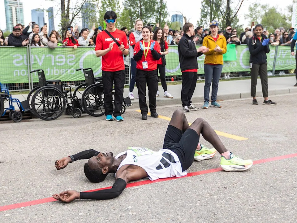 Nageso Nyafaro Tuse lays on the ground after finishing first in the Servus Calgary Marathon on Sunday, May 24, 2026 with a time of 2:22:18.