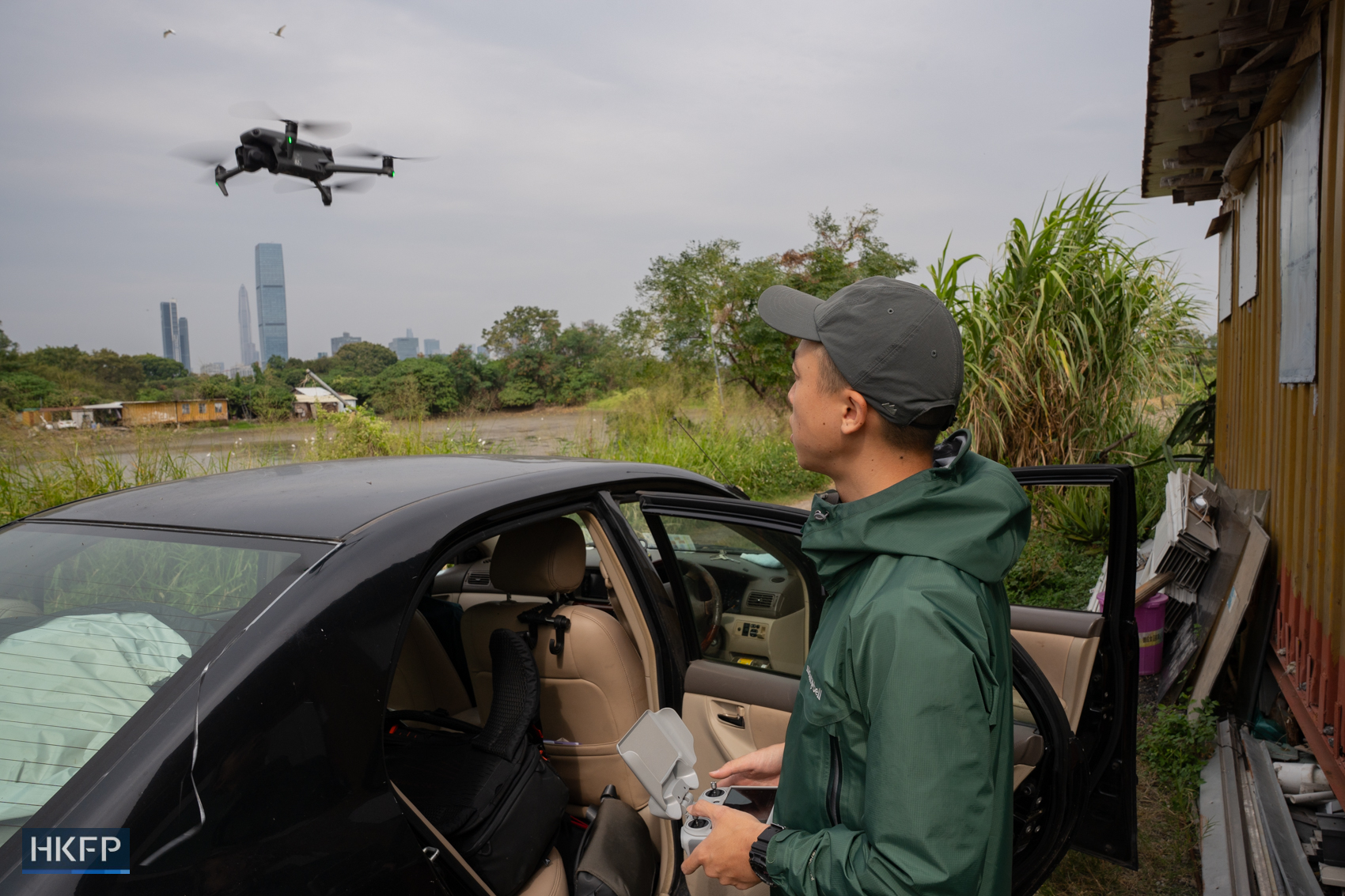 Fung Hon-shing operates a drone in Yuen Long on November 18, 2025. Photo: Kyle Lam/HKFP.