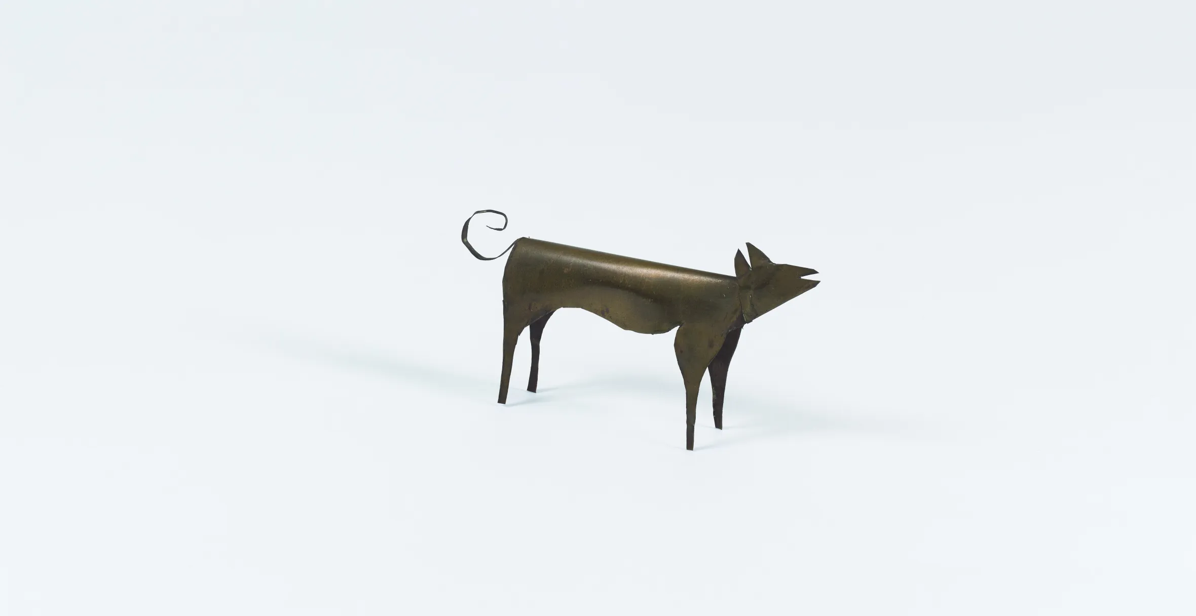Sculpture of a dog made from brass sheet metal.