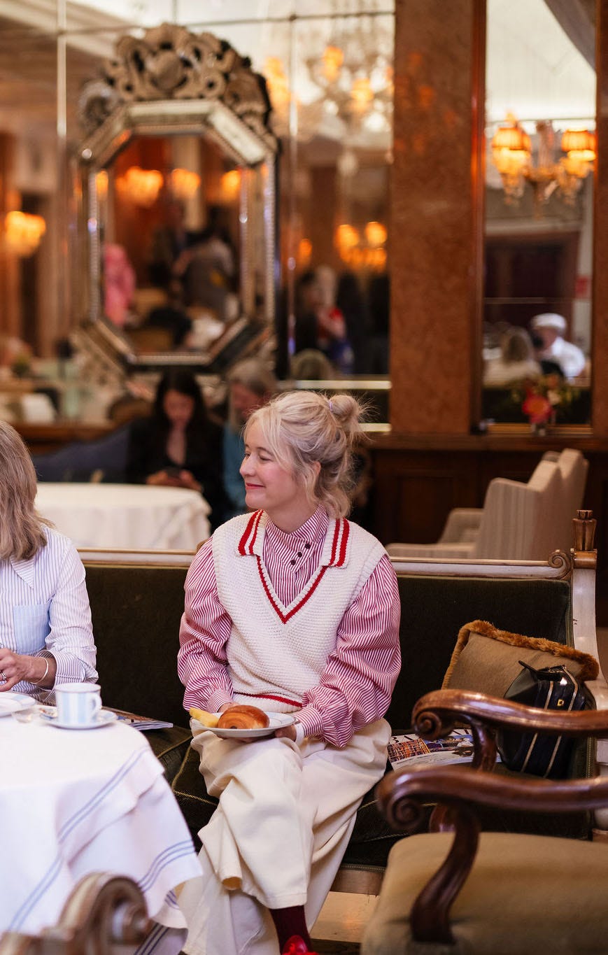 Woman sitting in a café with a plate of food Woman sitting in a café with a plate of food