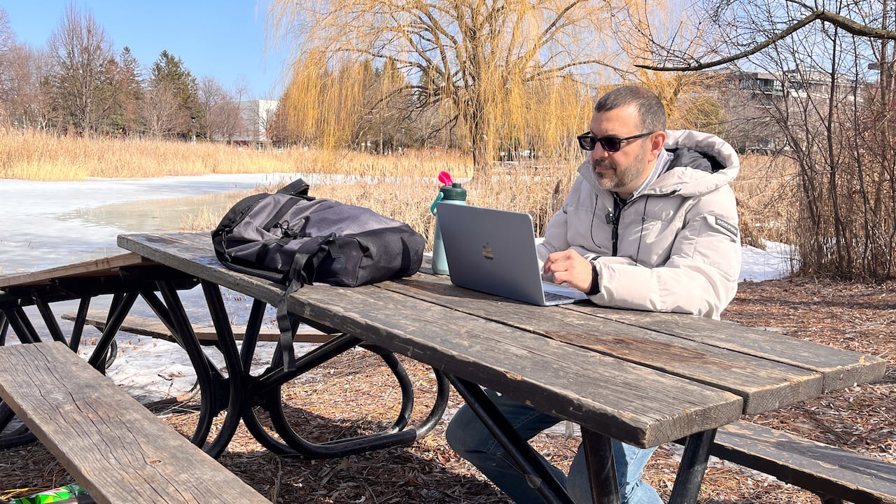 man on park picnic table