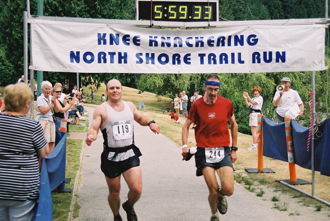 A man crosses the finish line in a race.