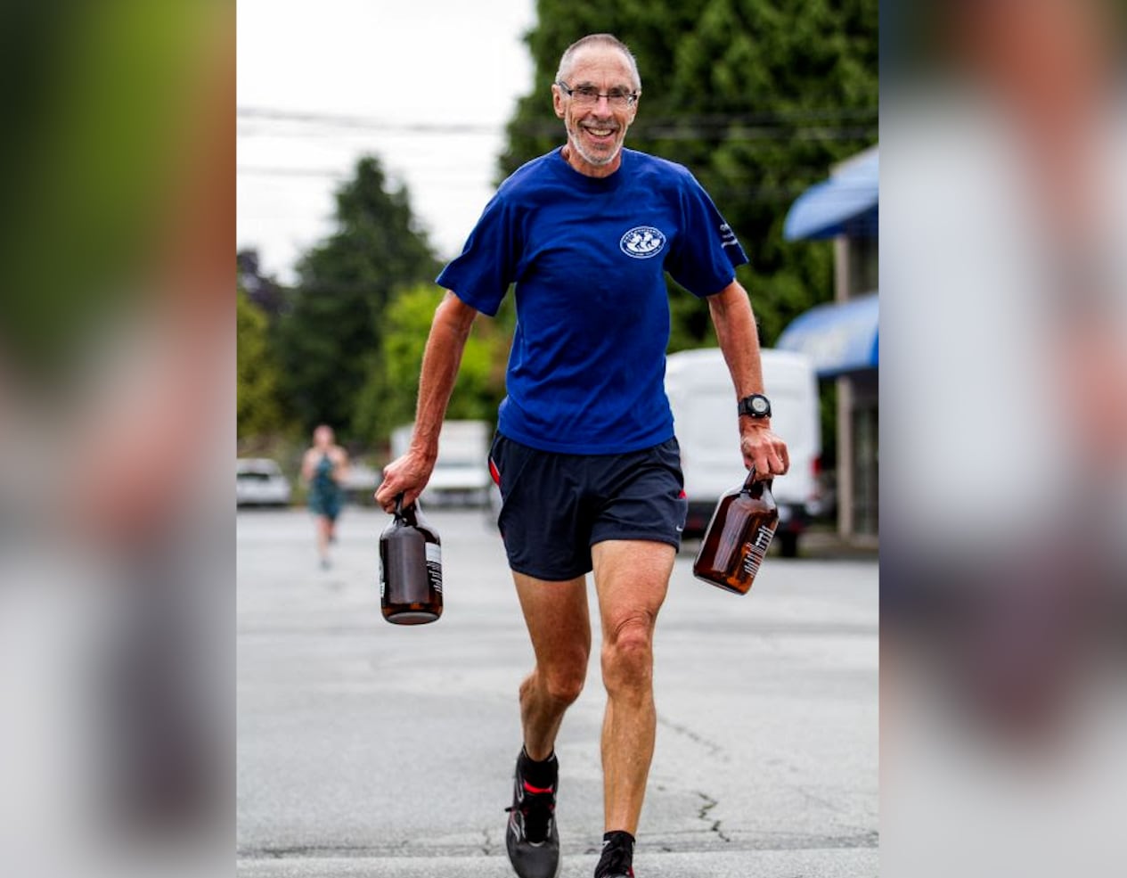 A man seen running while holding two large jugs of beer.