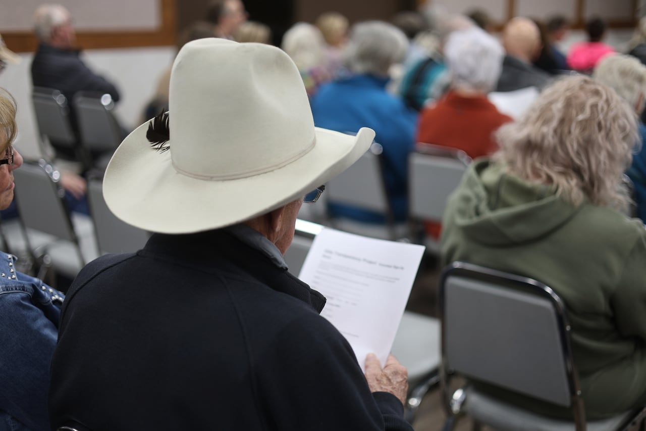 A man looks at a paper in a meeting room.